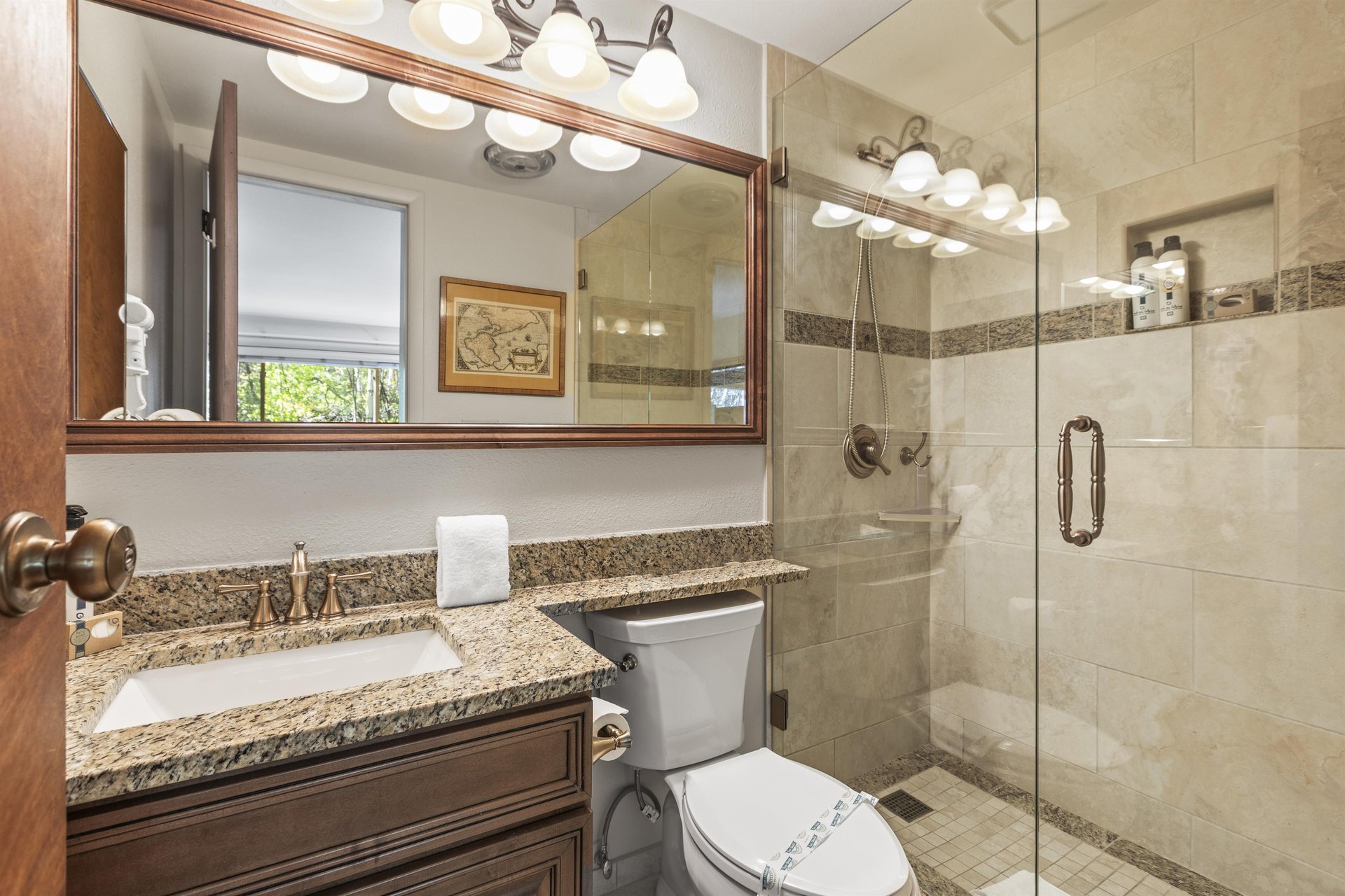 Snow Flower 135s en suite bathroom with walk in tiled shower, wooden cabinet and granite vanity.