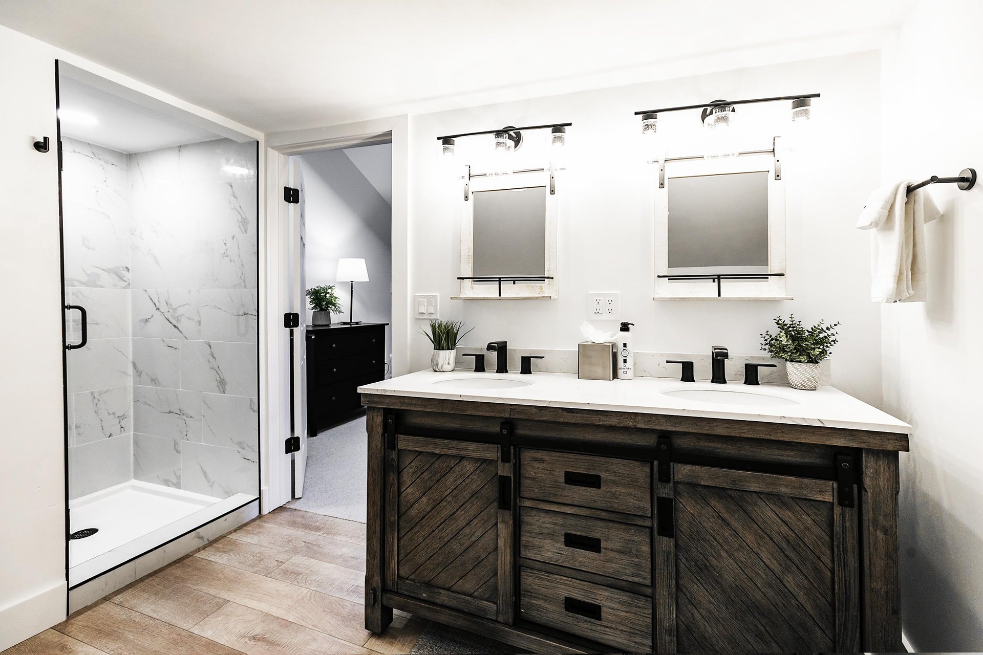 Loft bathroom with dual vanity, barn wood cabinetry and walk in shower