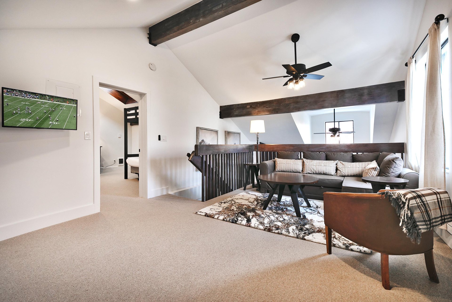 Wall mounted TV in the loft area, sectional opens to sofa sleeper bed