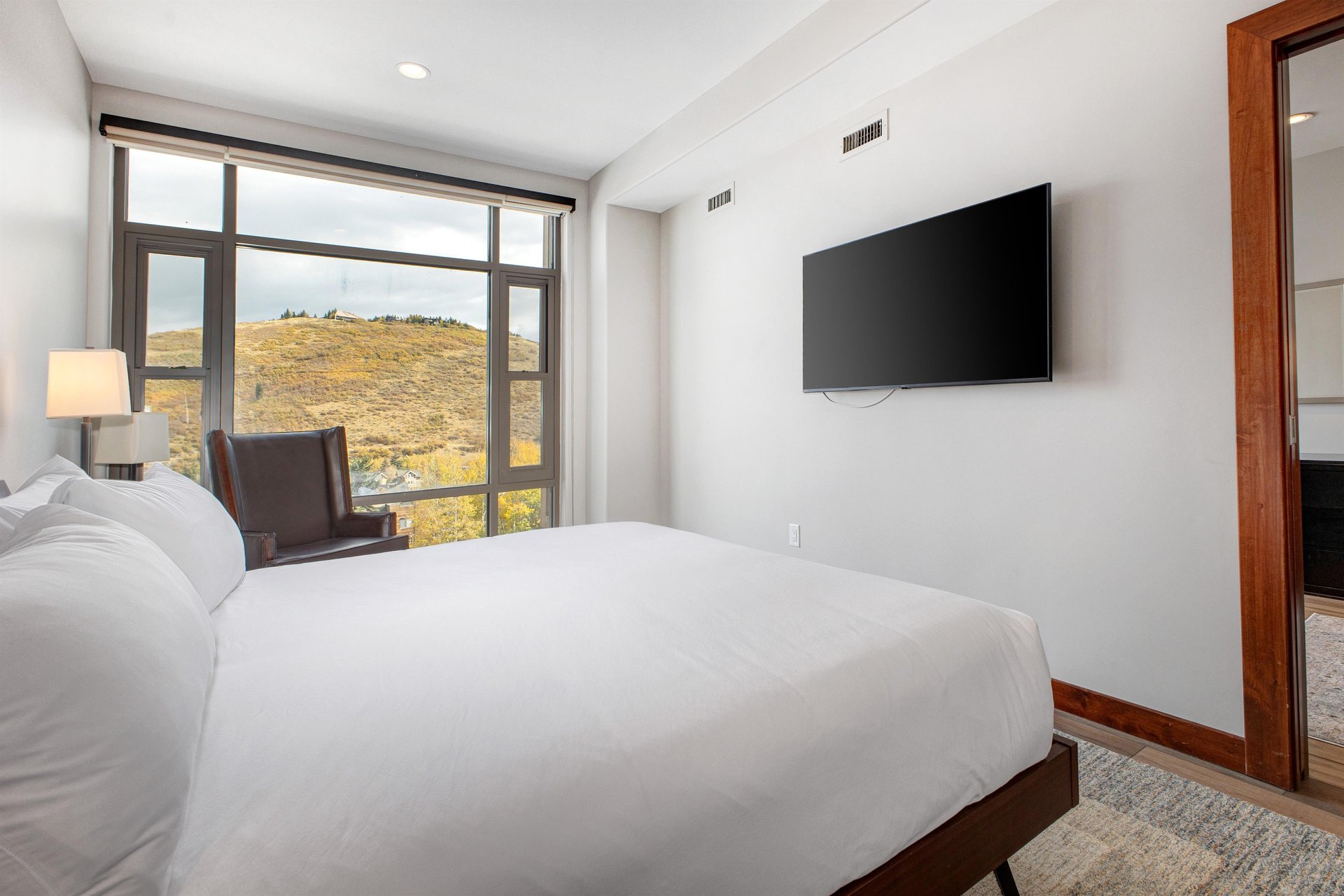 Lowell 402 main suite with a king size bed and a flat screen TV.