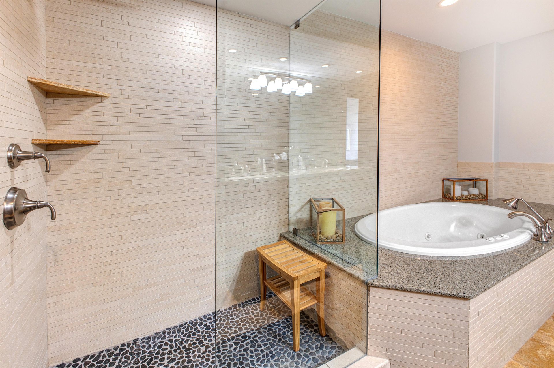Lowell 402 main suite bathroom with double sink vanity, walk in shower and bathtub.