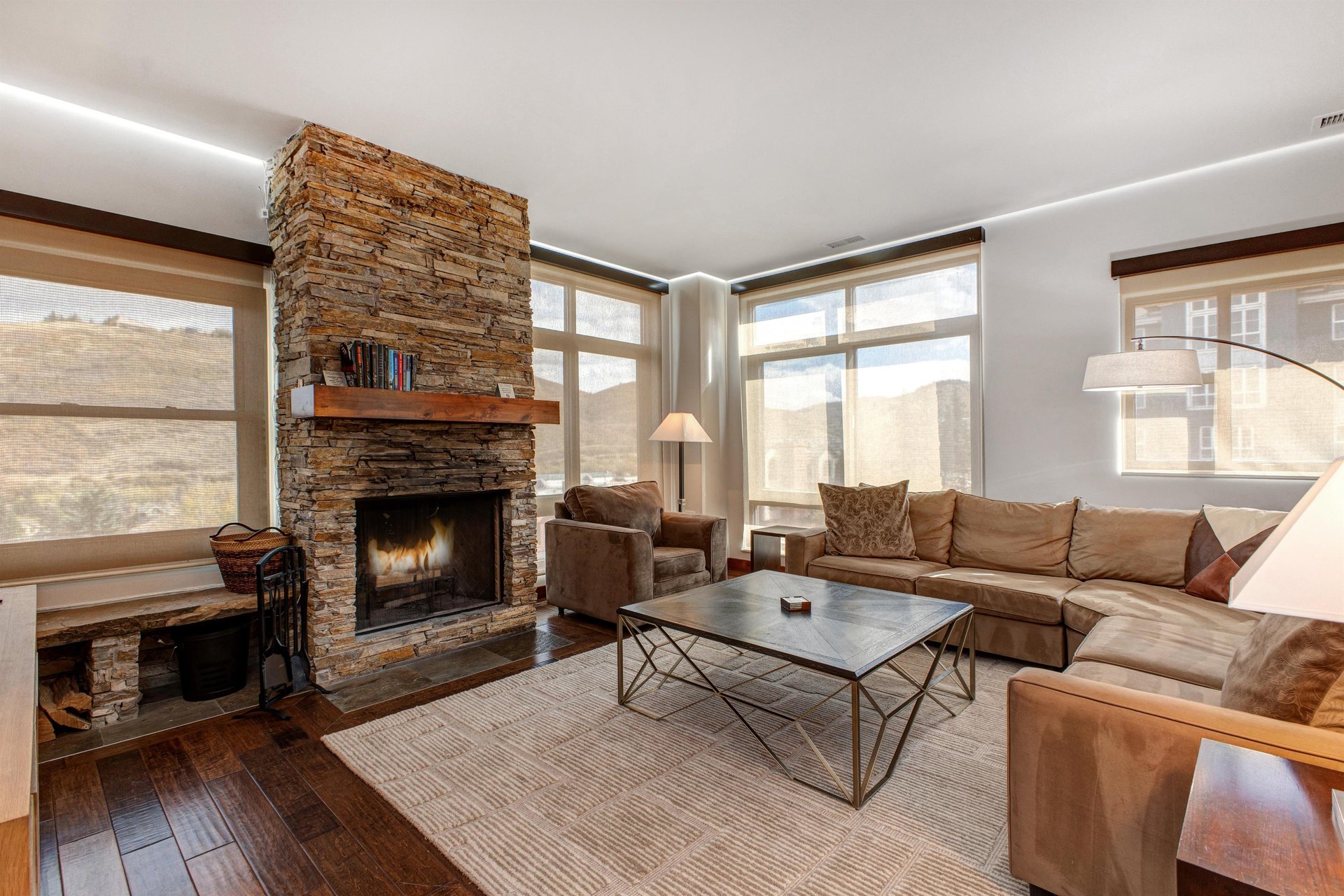 Lowell 402 living room with blinds lowered with gas burning fireplace.