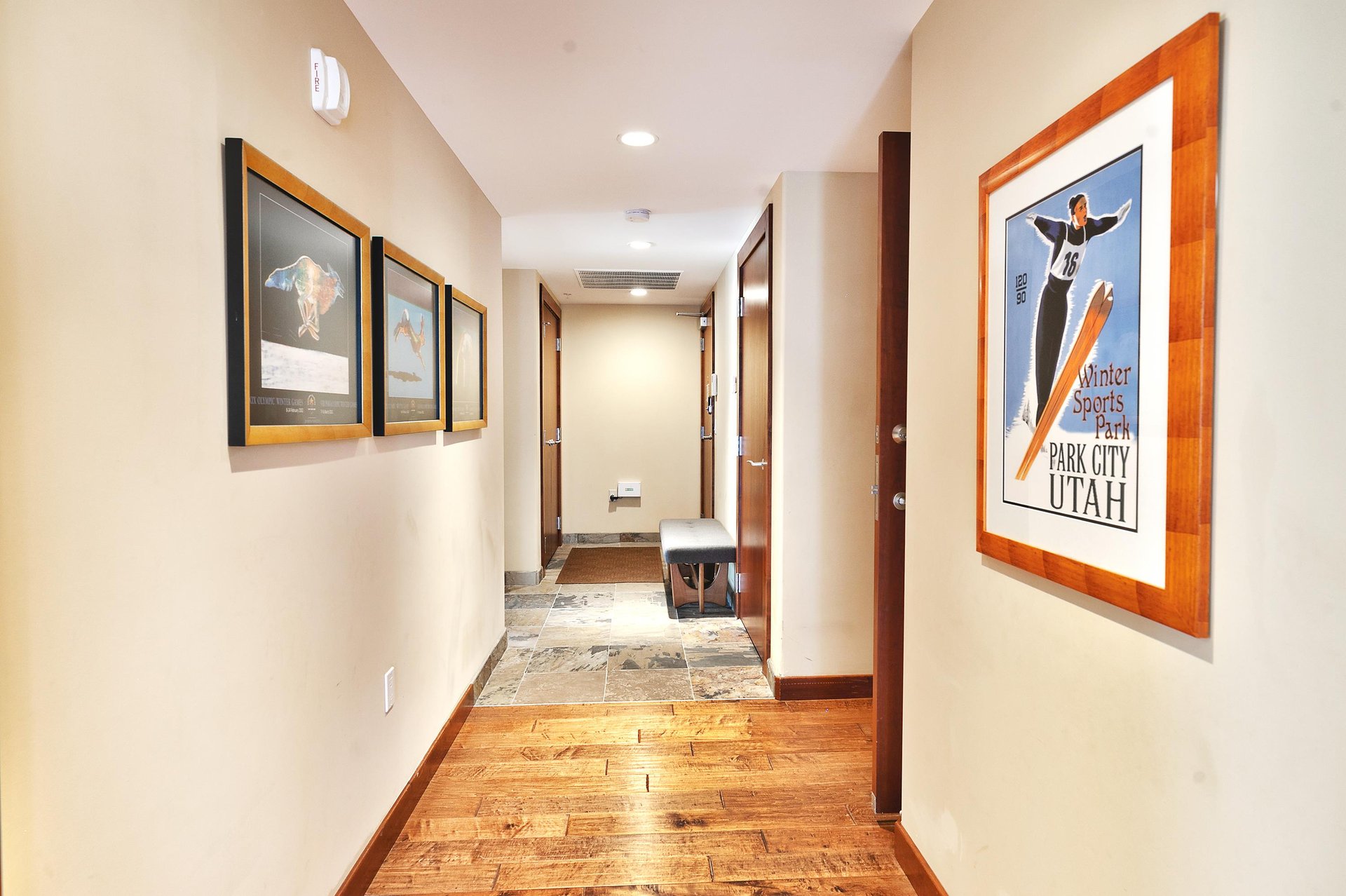 Second entryway with bench and slate stone tile before going to hardwood floor