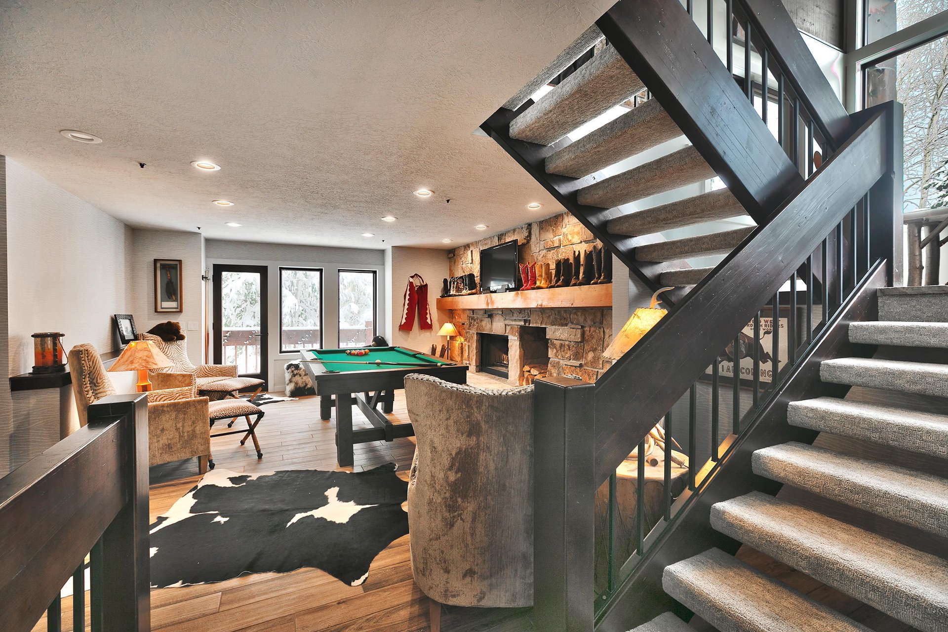 A second living room with a , sitting area, pool table and flat screen TV.