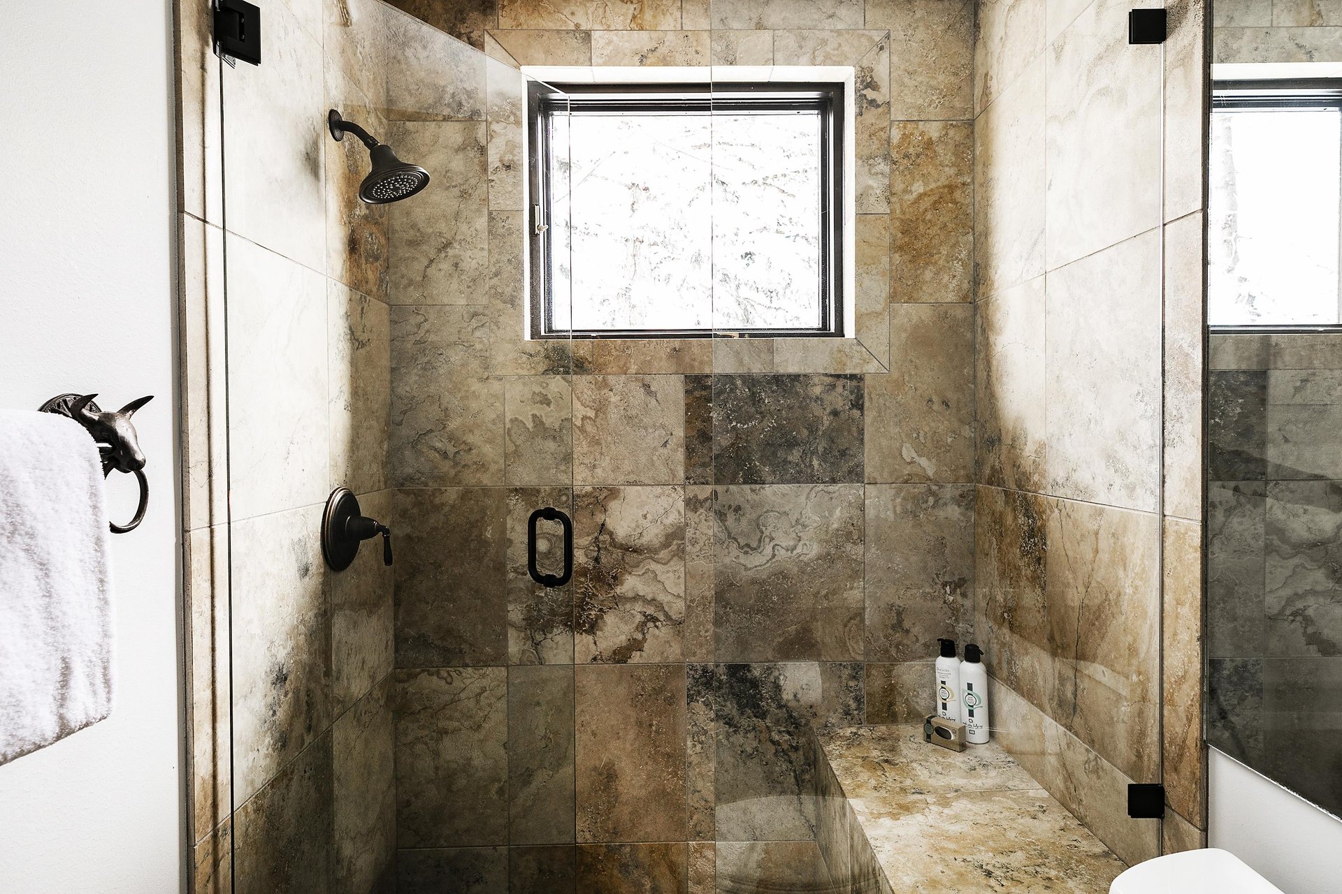 A bathroom with a walkin shower.