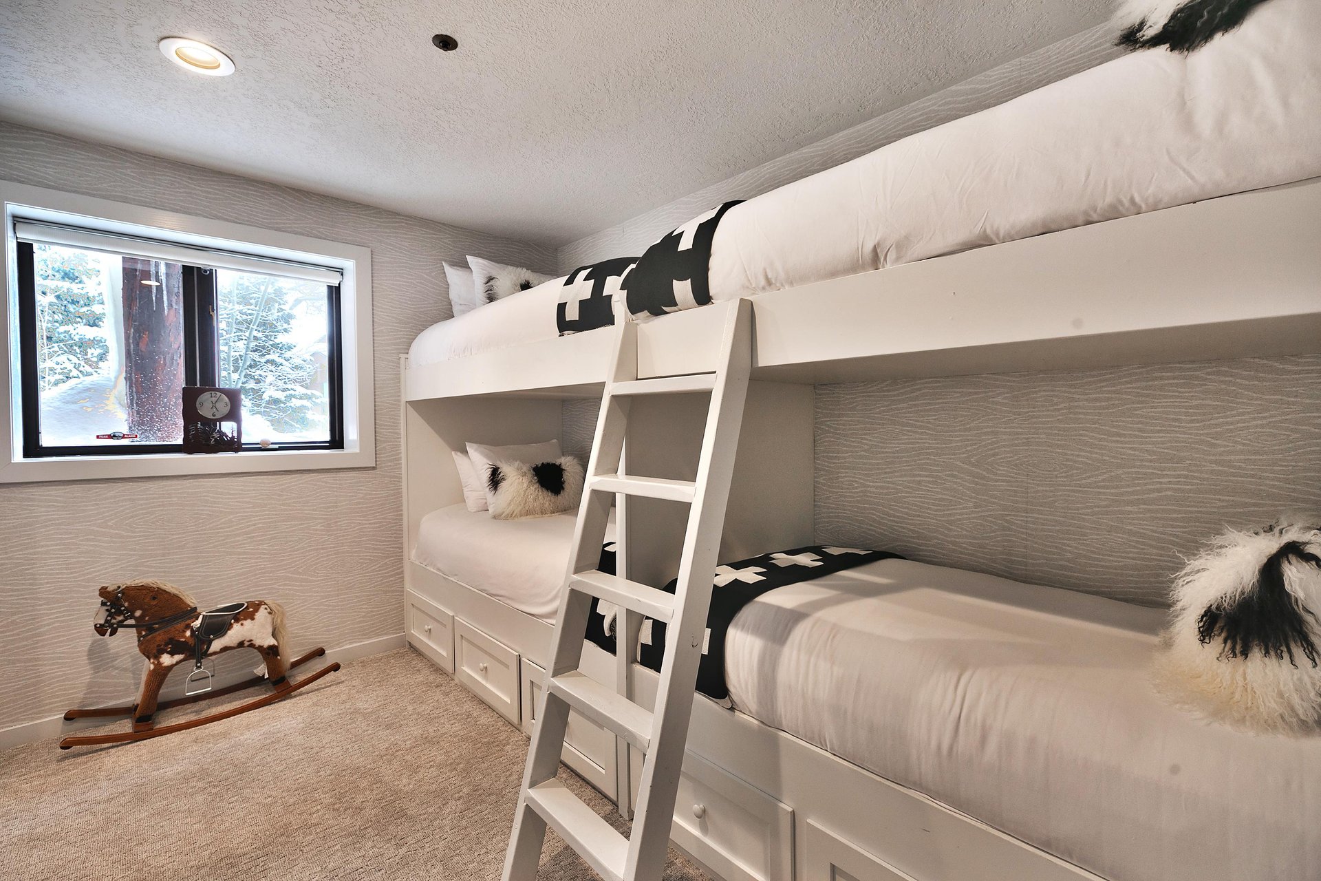 A bedroom with two sets of twin size bunk beds.