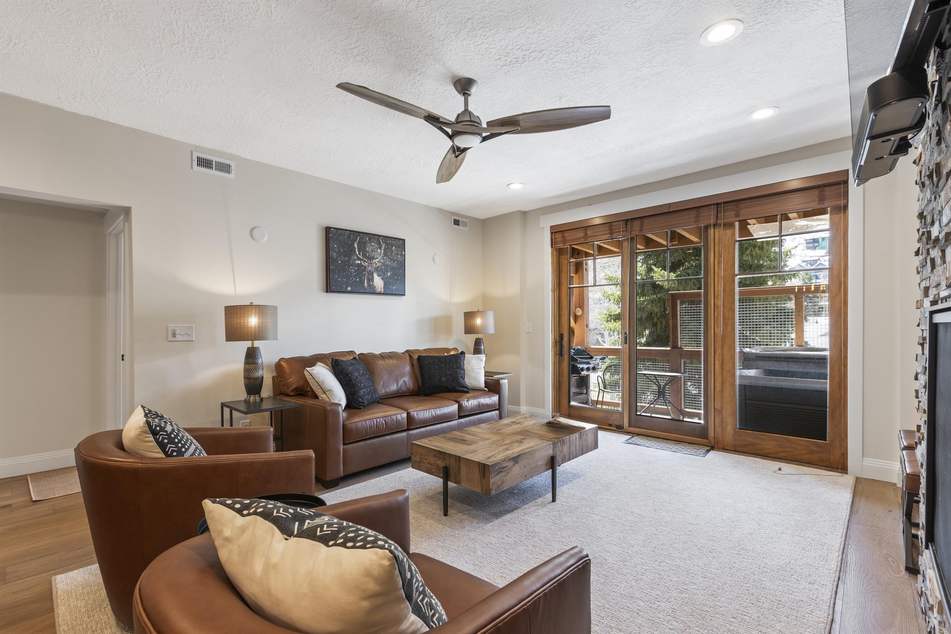 Town Pointe B204s living room a leather couch and two leather love seats.