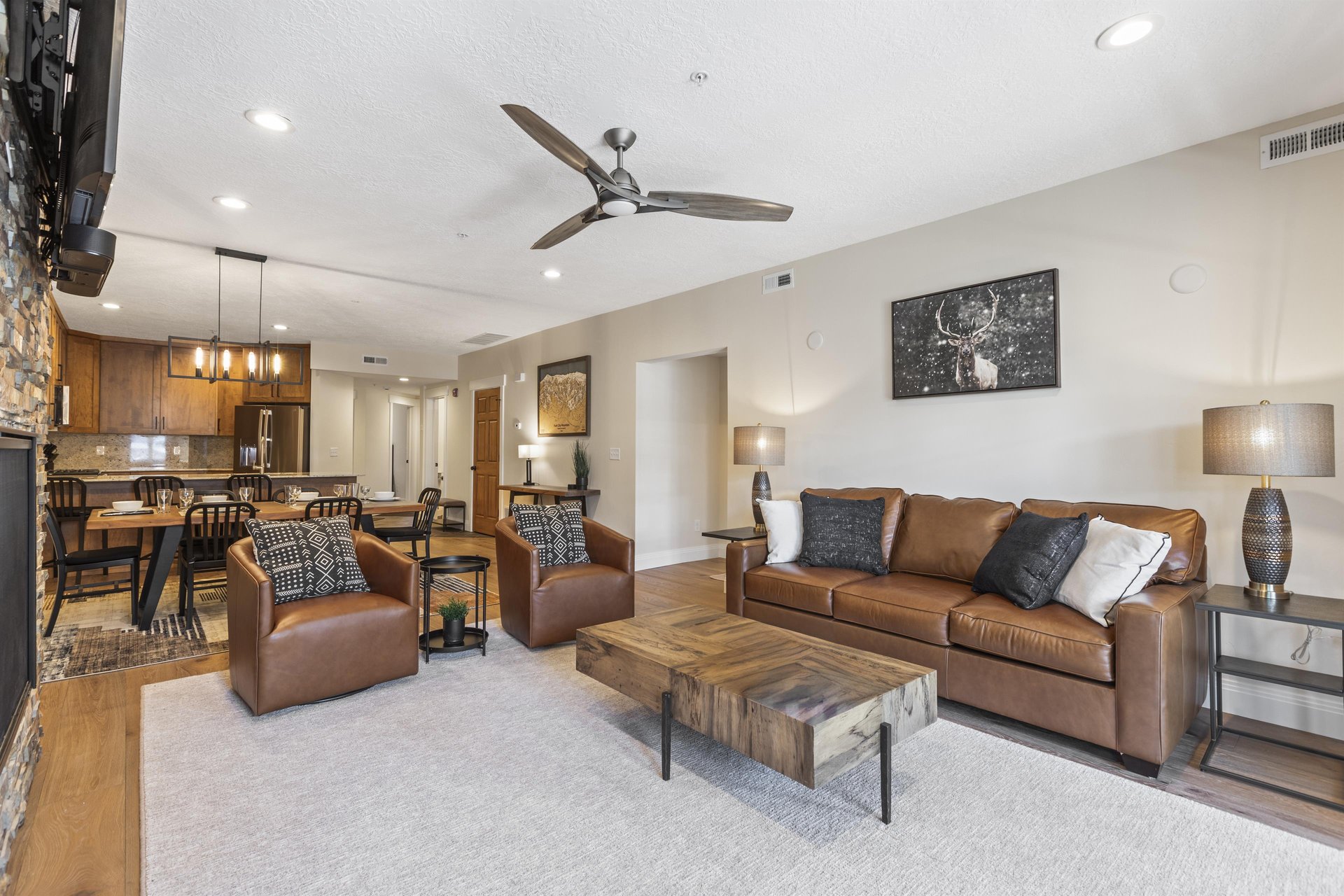Town Pointe B204s living room a leather couch and two leather love seats.