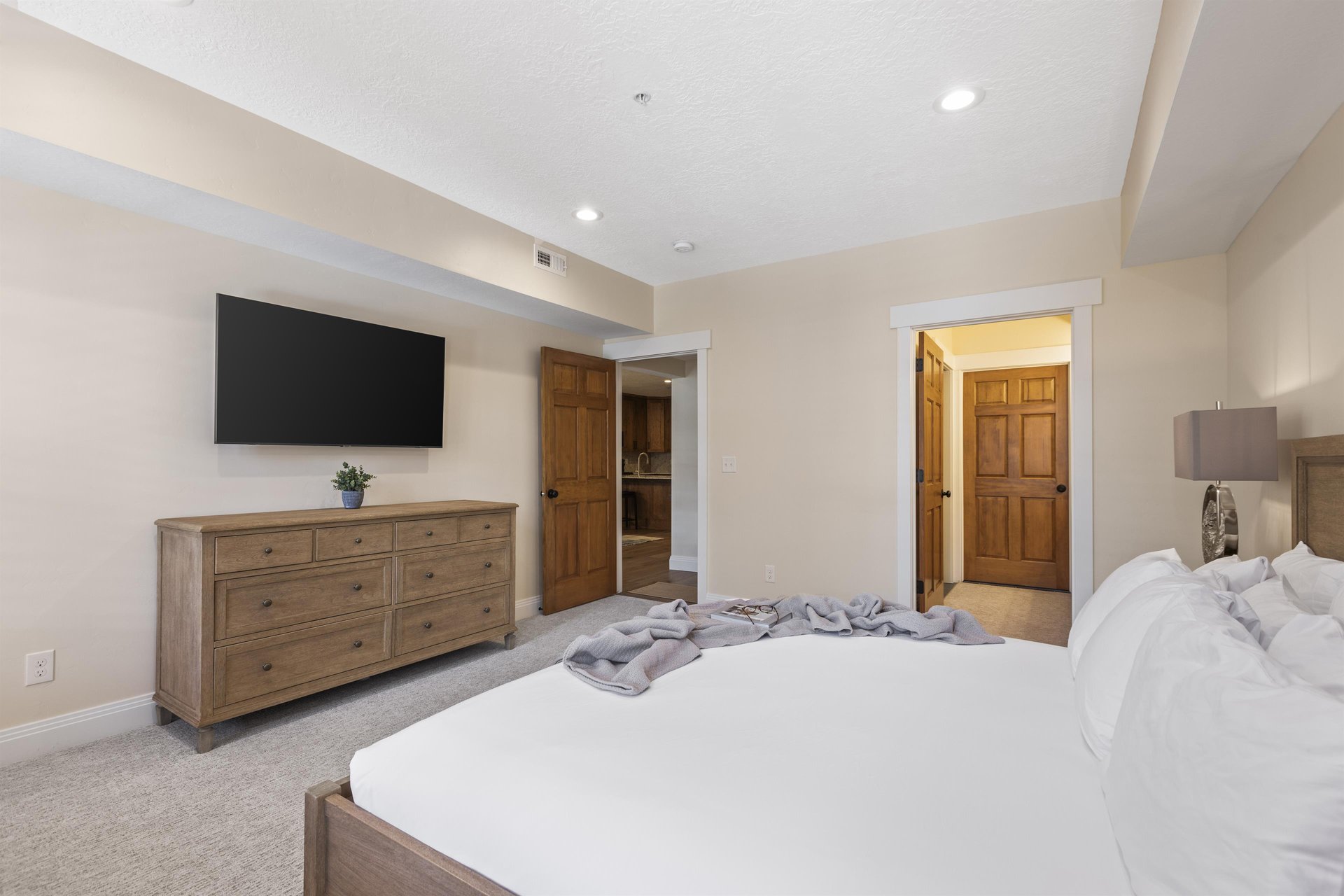 The second suite with a king size bed, dresser, and flat screen TV.
