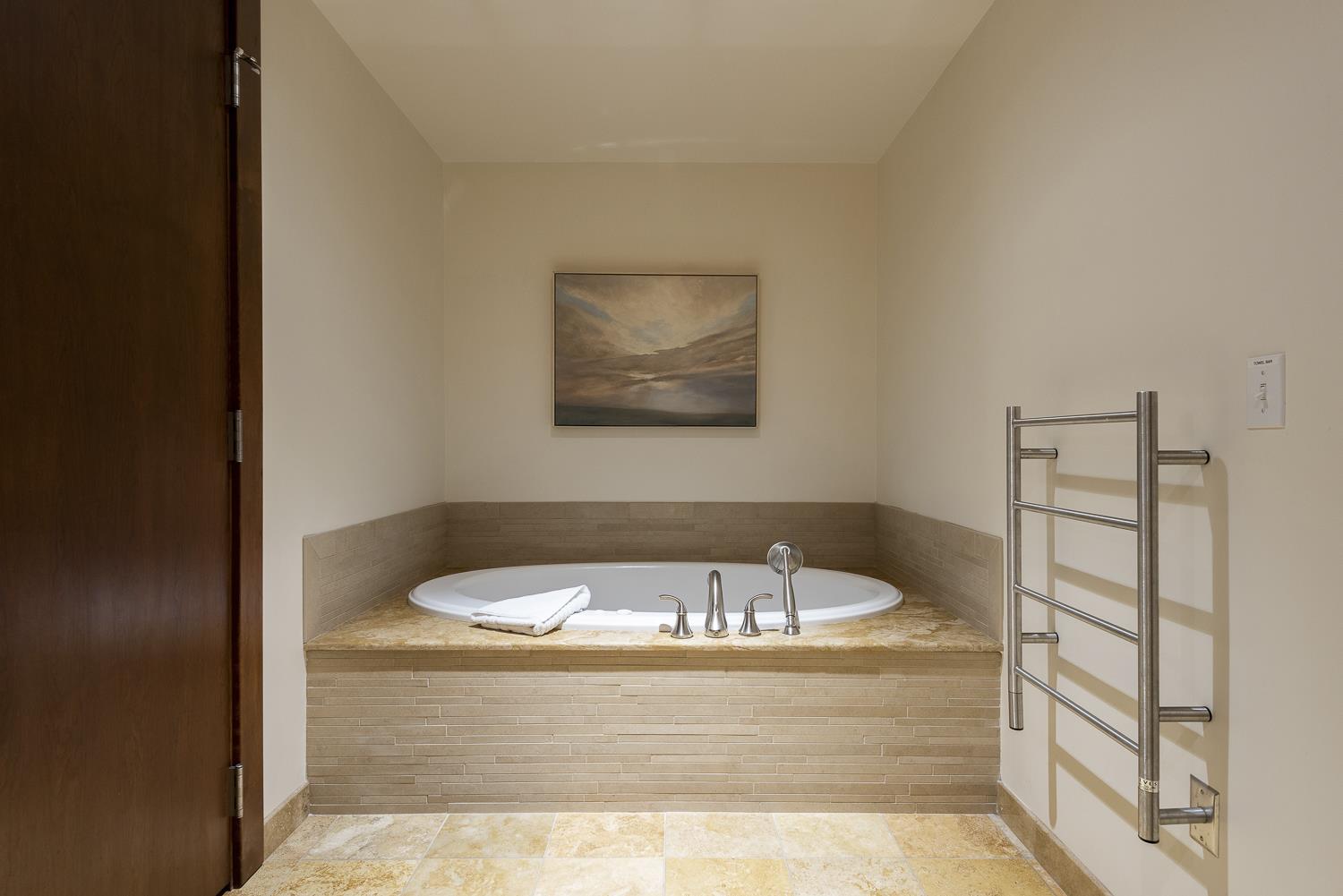 Fully immersible tub with heated towel rack