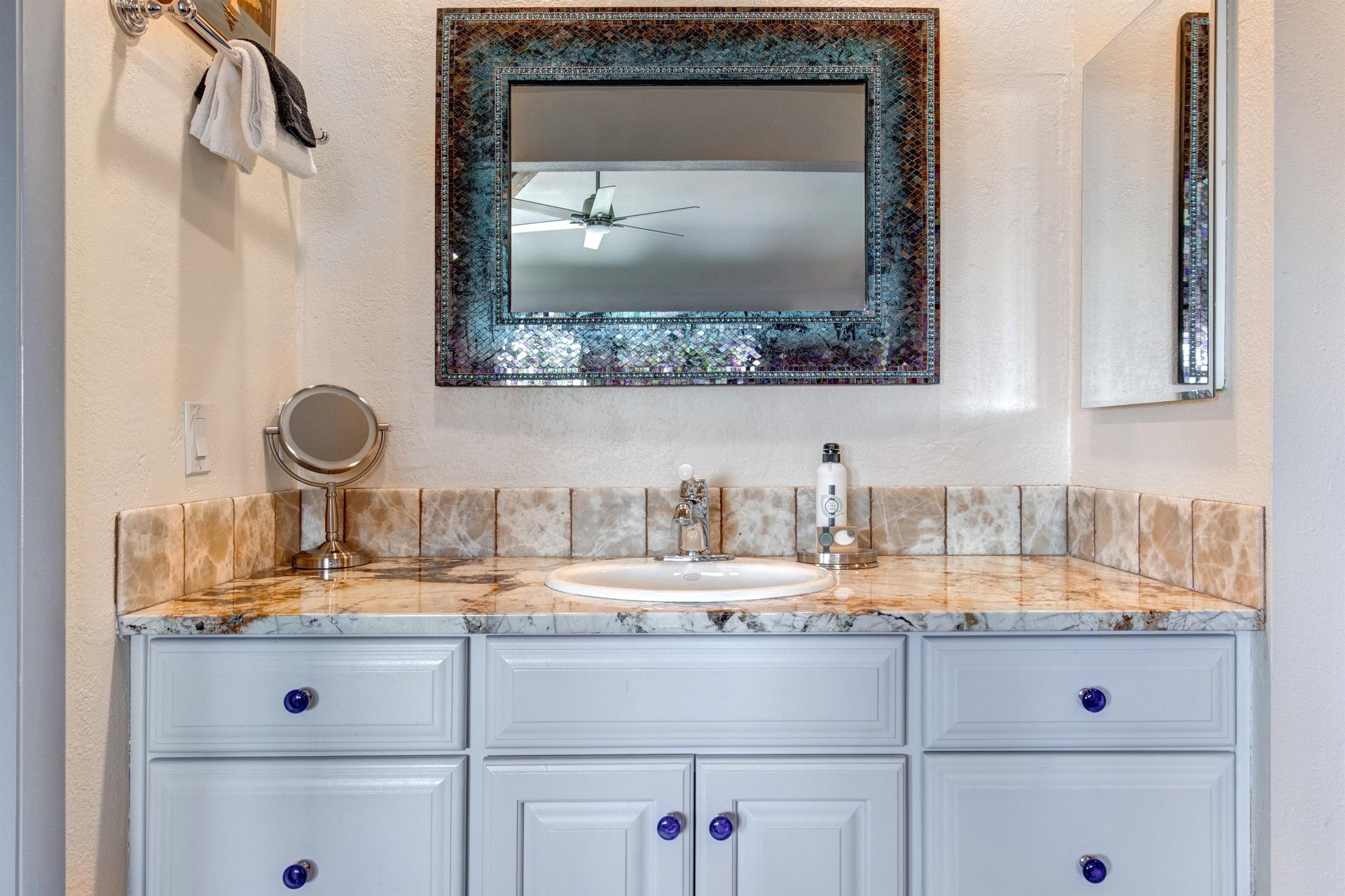 The en suite bathroom has a single sink vanity.