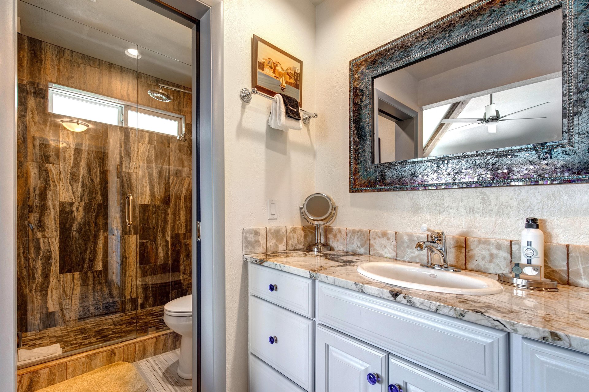The en suite bathroom has a single sink vanity and separate water closet.