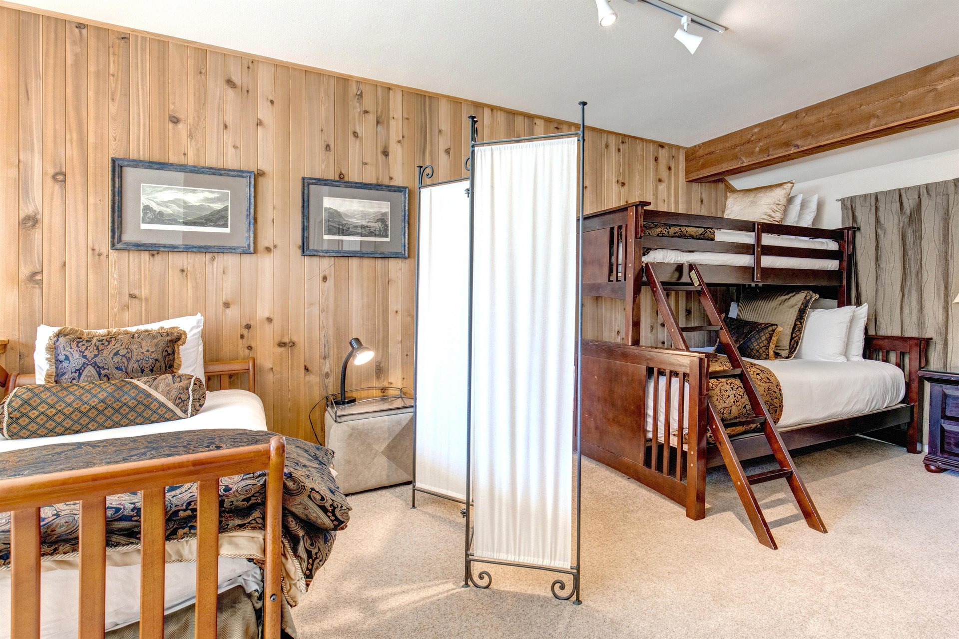The loft has a twin day bed and a bunk bed with a queen bed on the bottom and twin bed on the top.