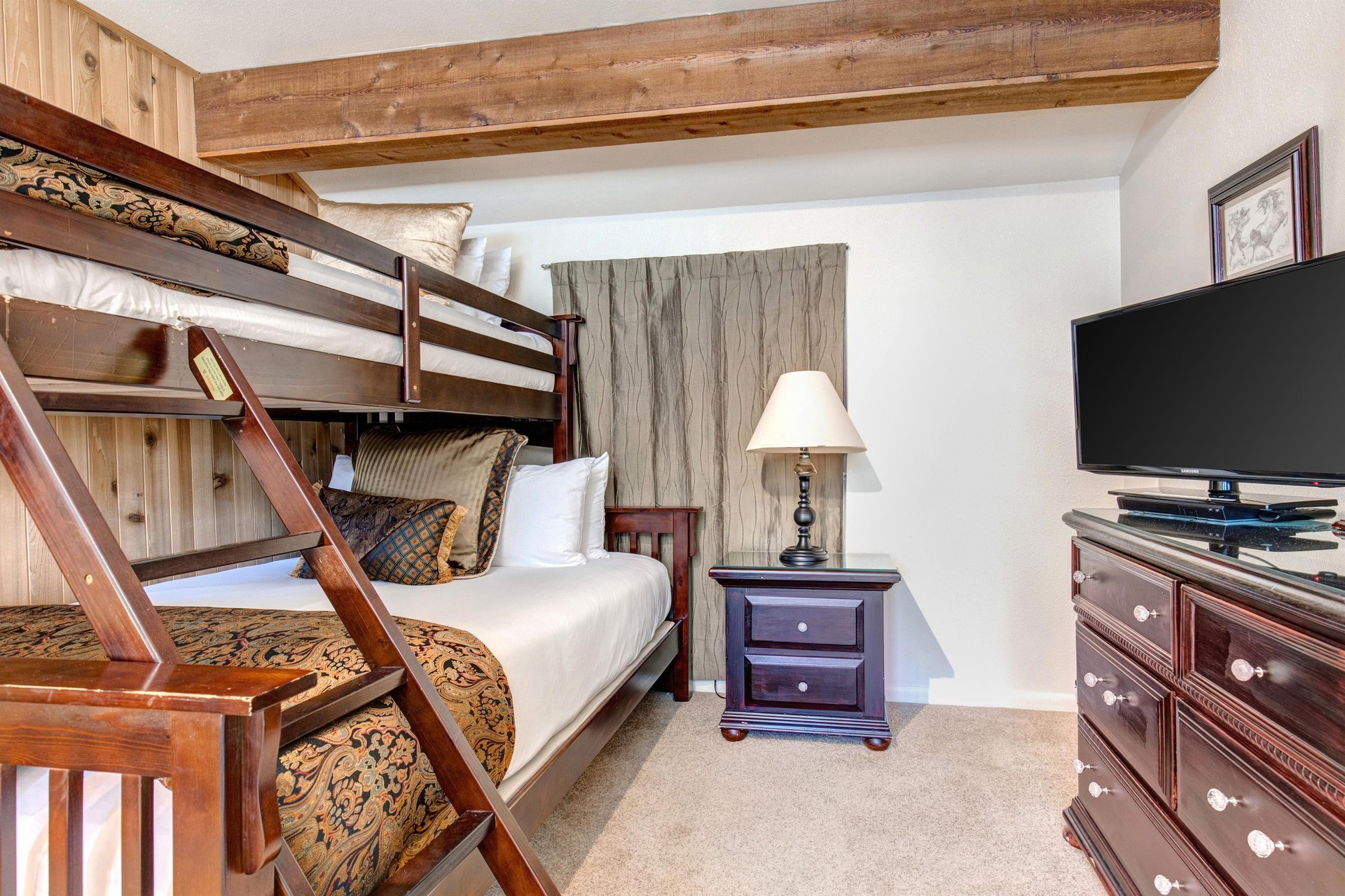 The loft has a bunk bed with a queen bed on the bottom and twin bed on the top.