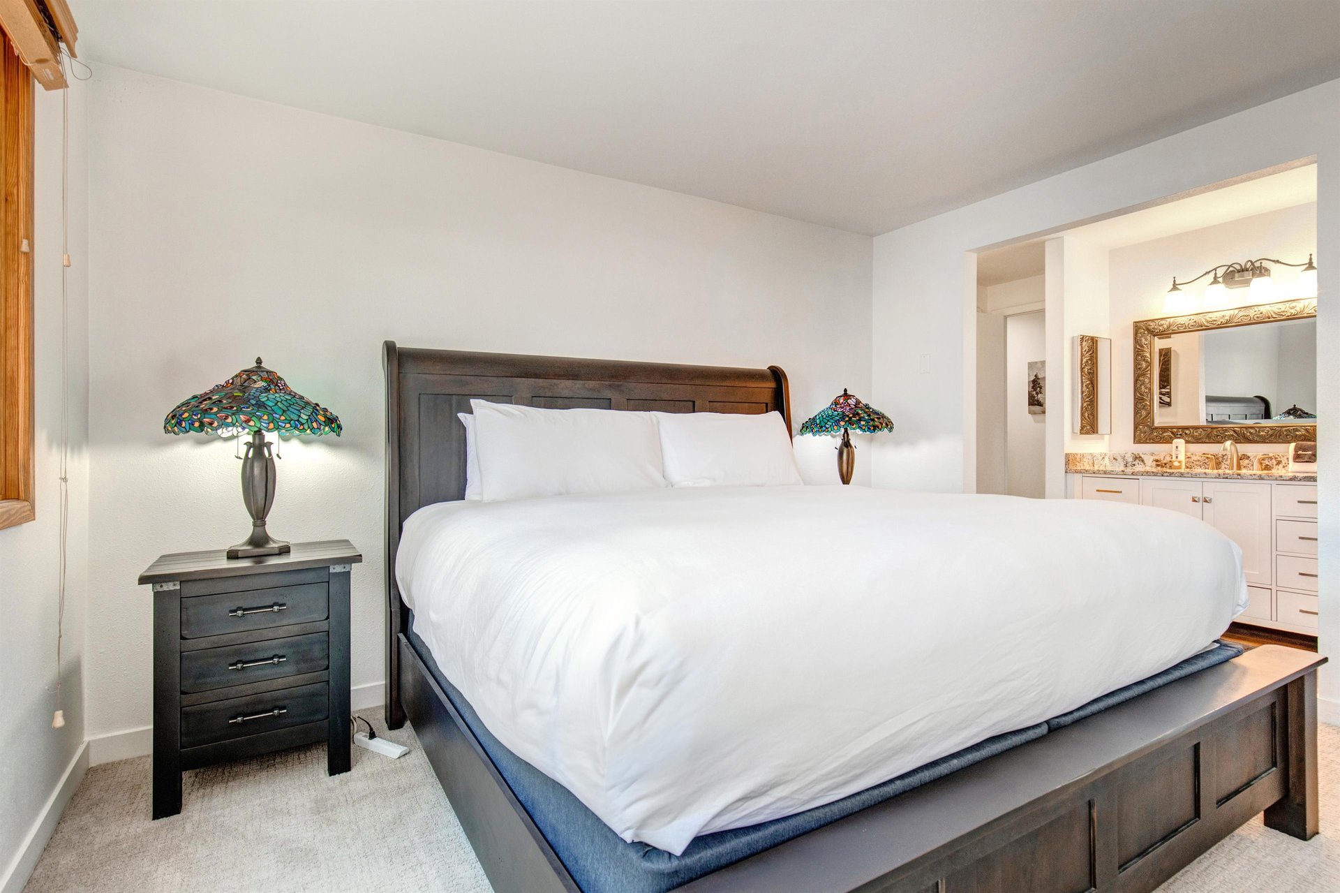 The main suite offers a kingsize bed and wooden furnishings.