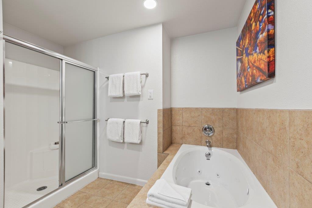 The en suite bathroom with deep soaker bathtub and walkin shower.