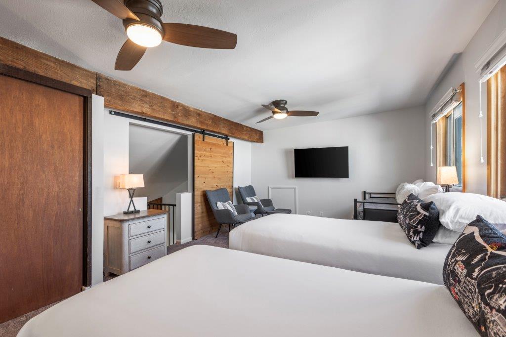 The loft with a twin size day bed, two twin size beds, and a sitting area.