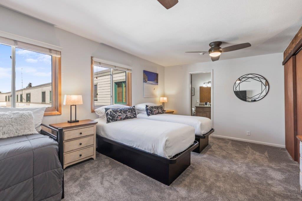 The loft with a twin size day bed, two twin size beds, and a sitting area.