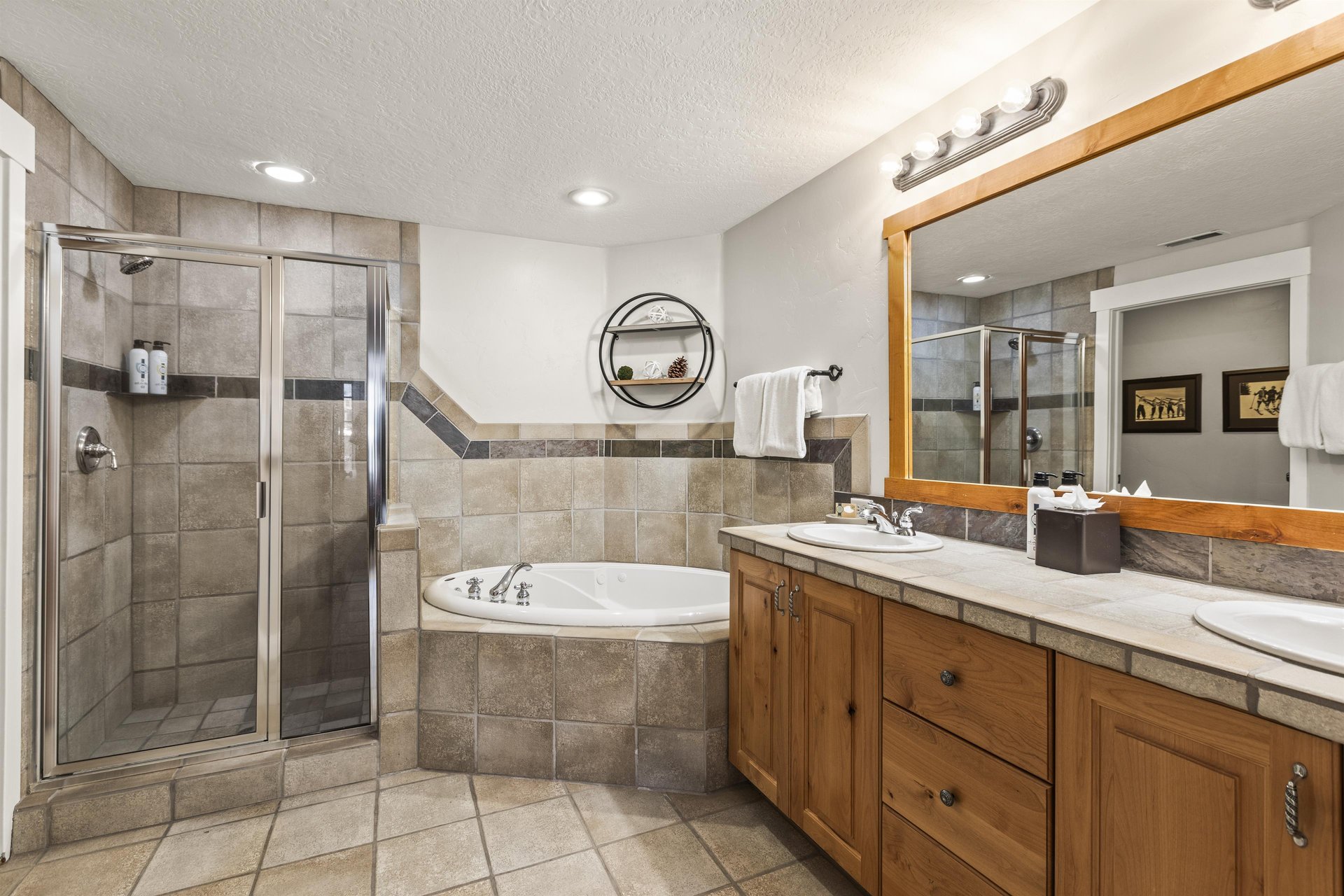 The en suite bathroom has a bathtub, walkin shower, and two sink vanity.