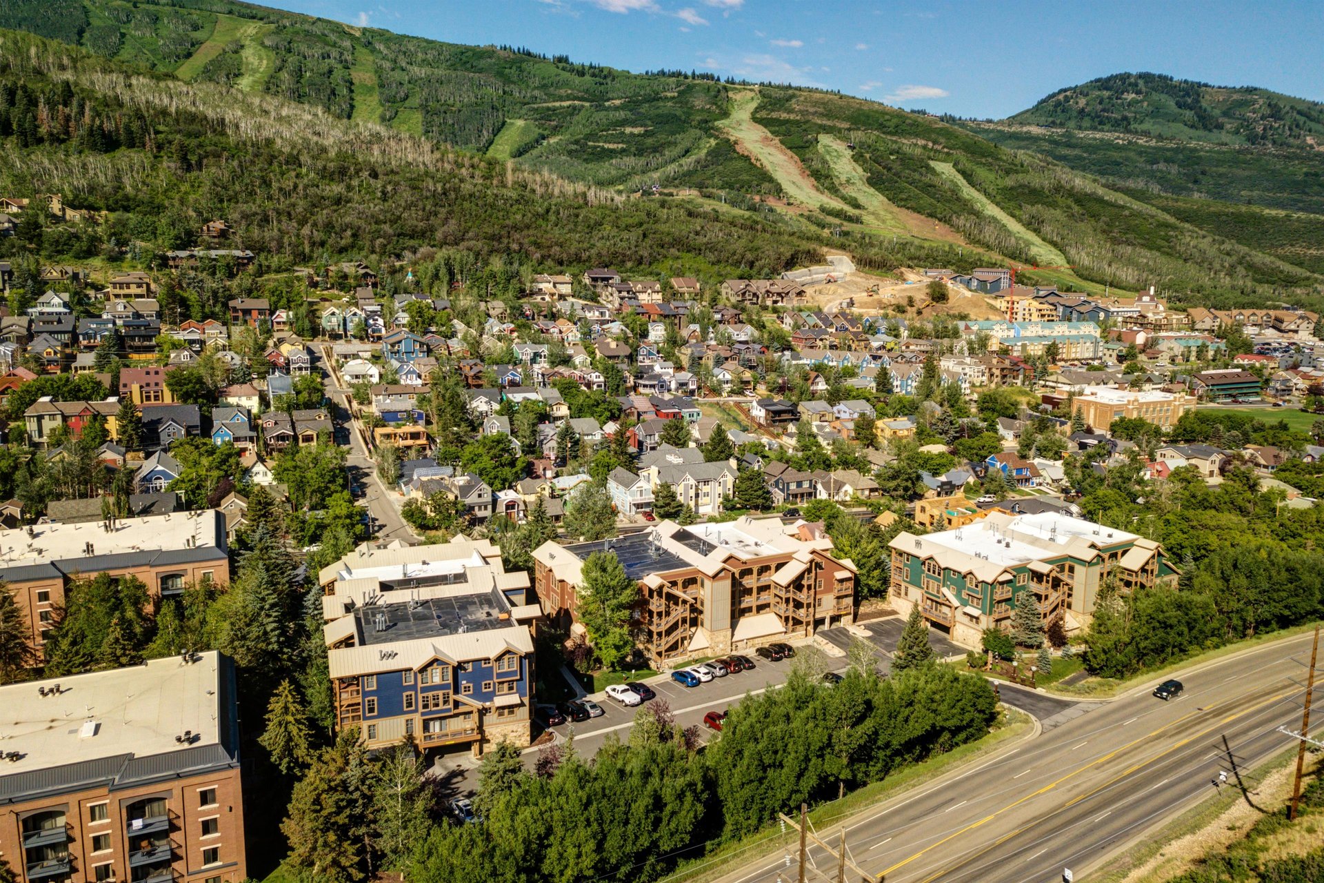Town Pointe Condos with the backdrop of Park City Mountain Resort in the summertime.