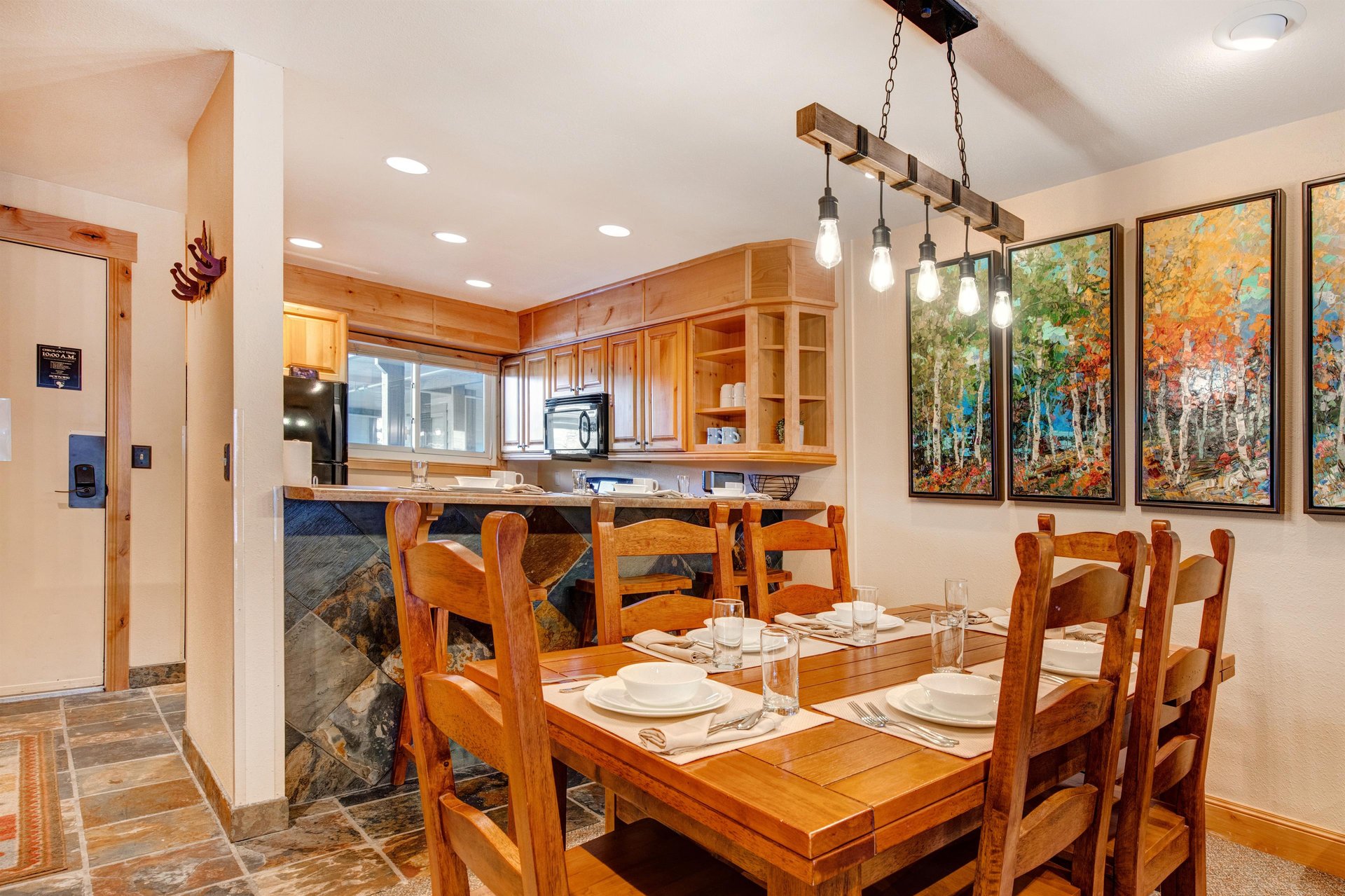 The dining table offers seating for 6 and crisp white dinnerware.