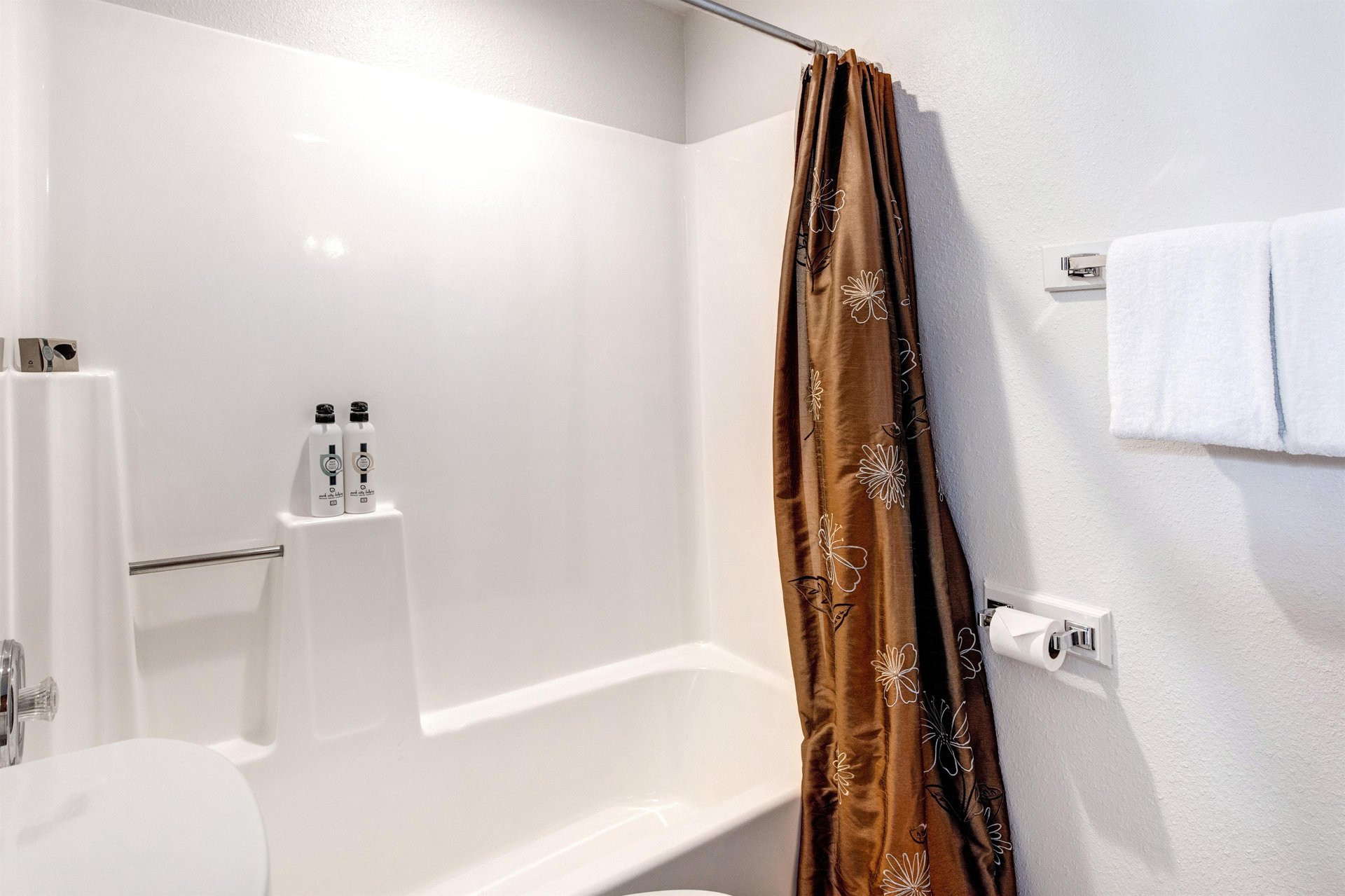 The shared bathroom has a bathtub and shower combination.