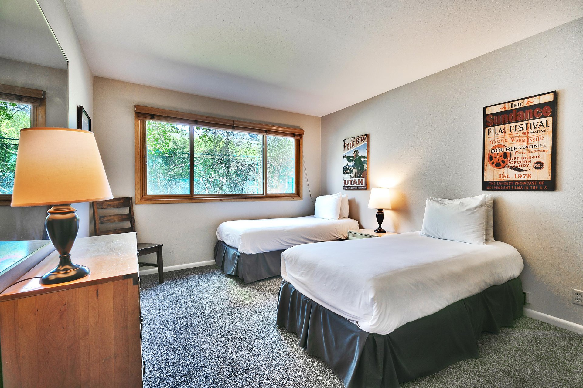 The second bedroom features two comfortable twinsized beds and an abundance of natural lights through the picture window