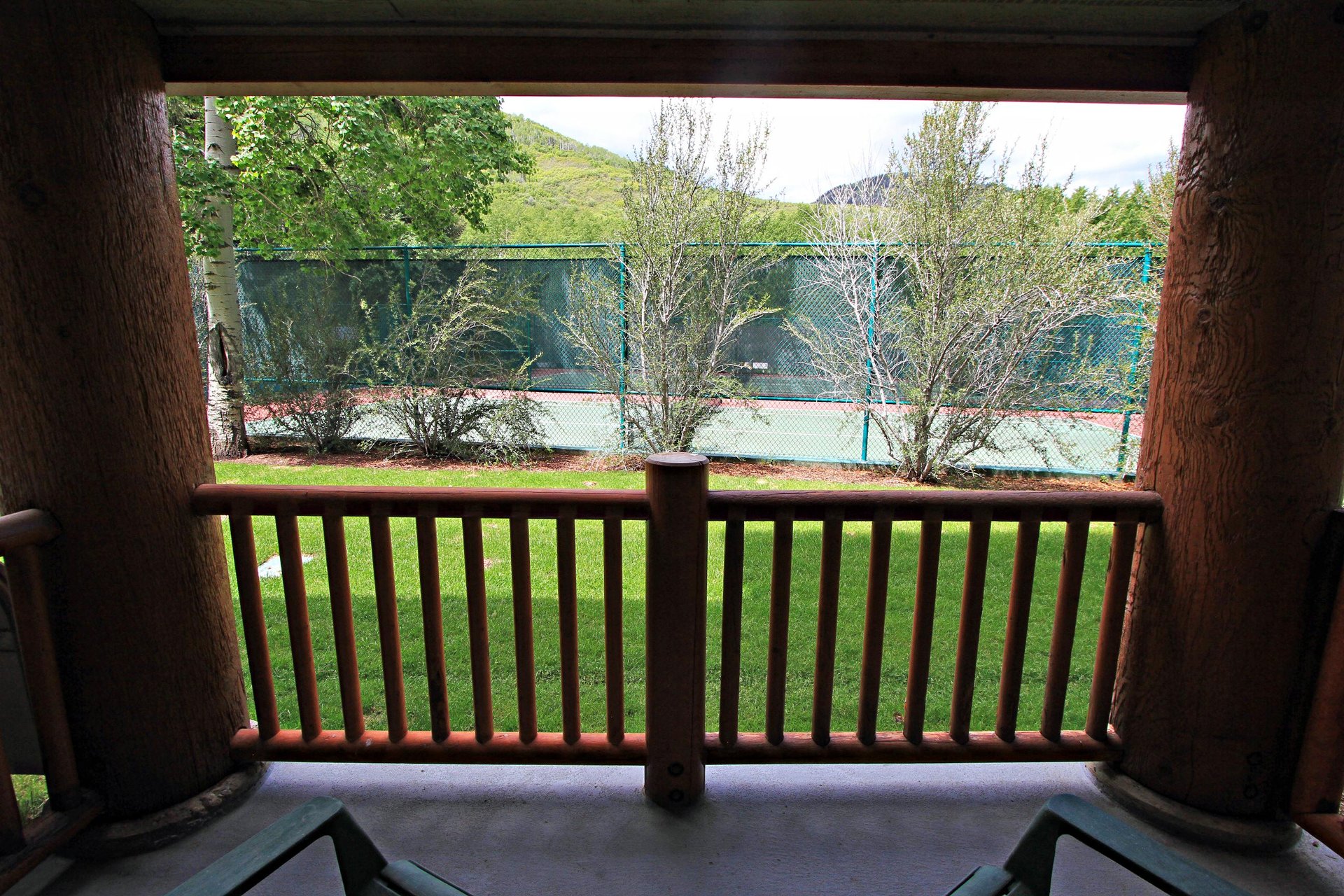 The private patio includes views of the tennis courts