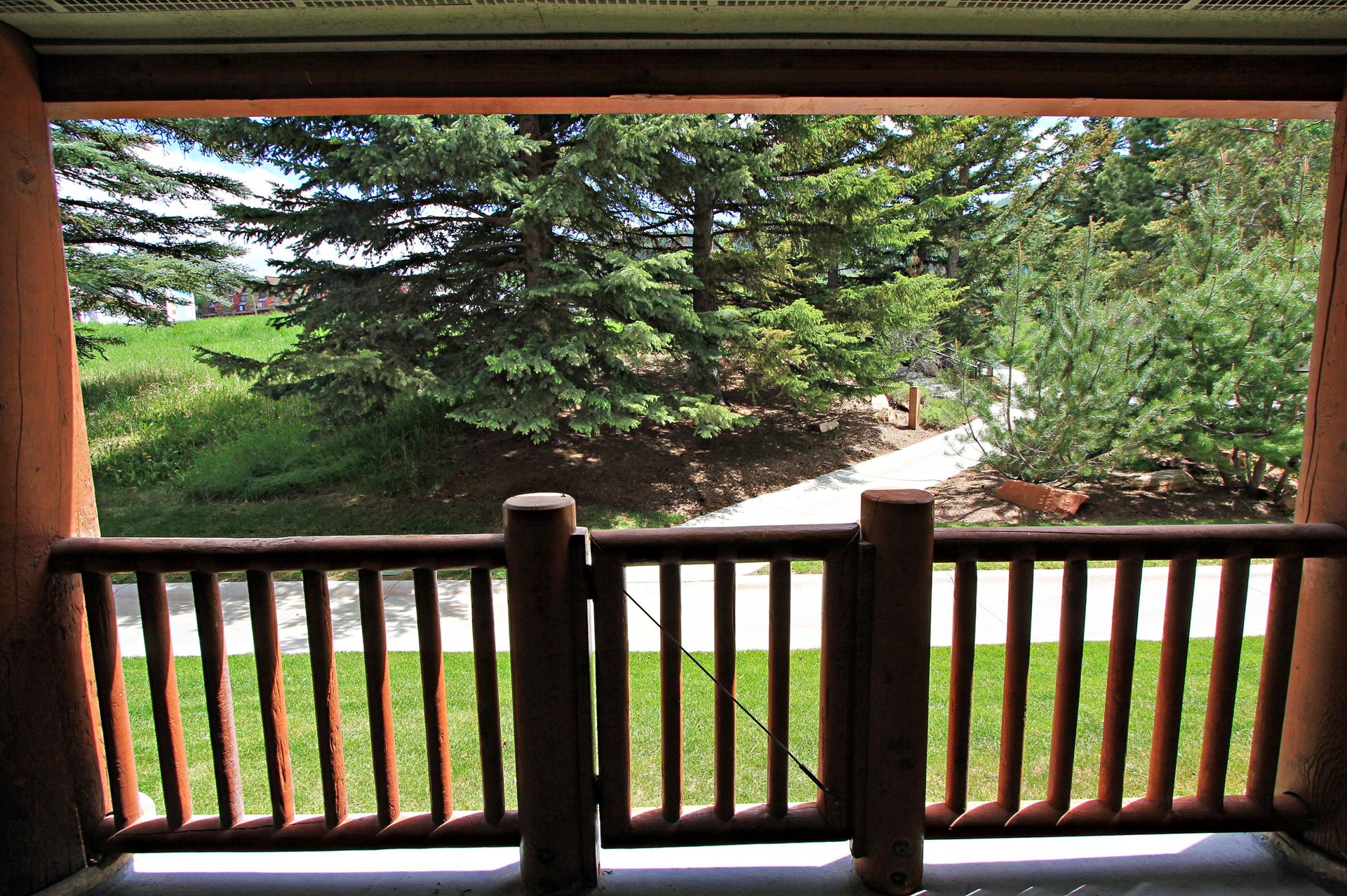 Private patio with views of the slopes during summer and walkway to Park City Mountain Resort.