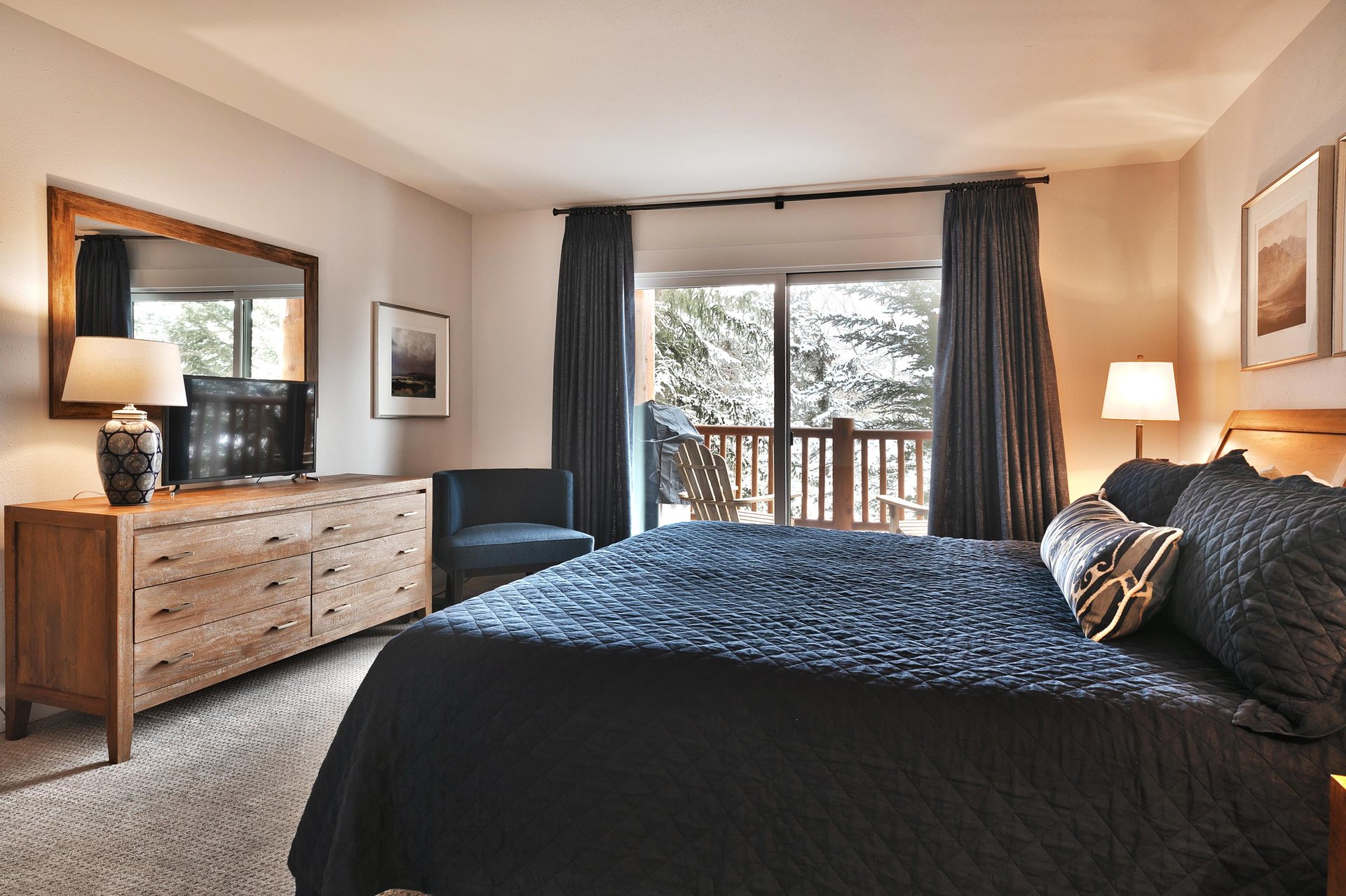 Main bedroom with flat screen TV and access to the private patio
