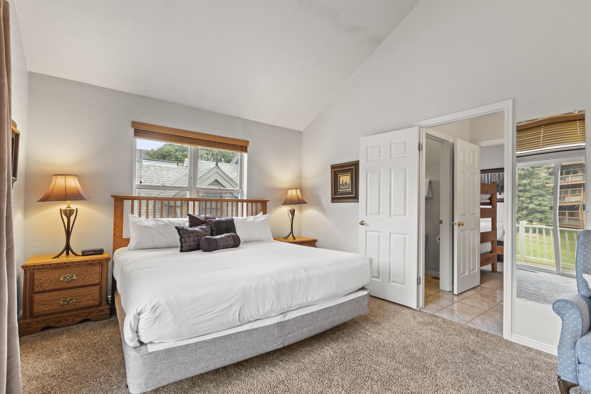 The spacious main suite with a king size bed and en suite bathroom.