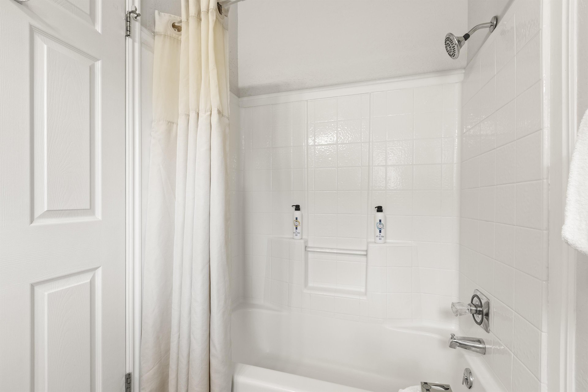 The en suite bathroom has a bathtub and shower combination.