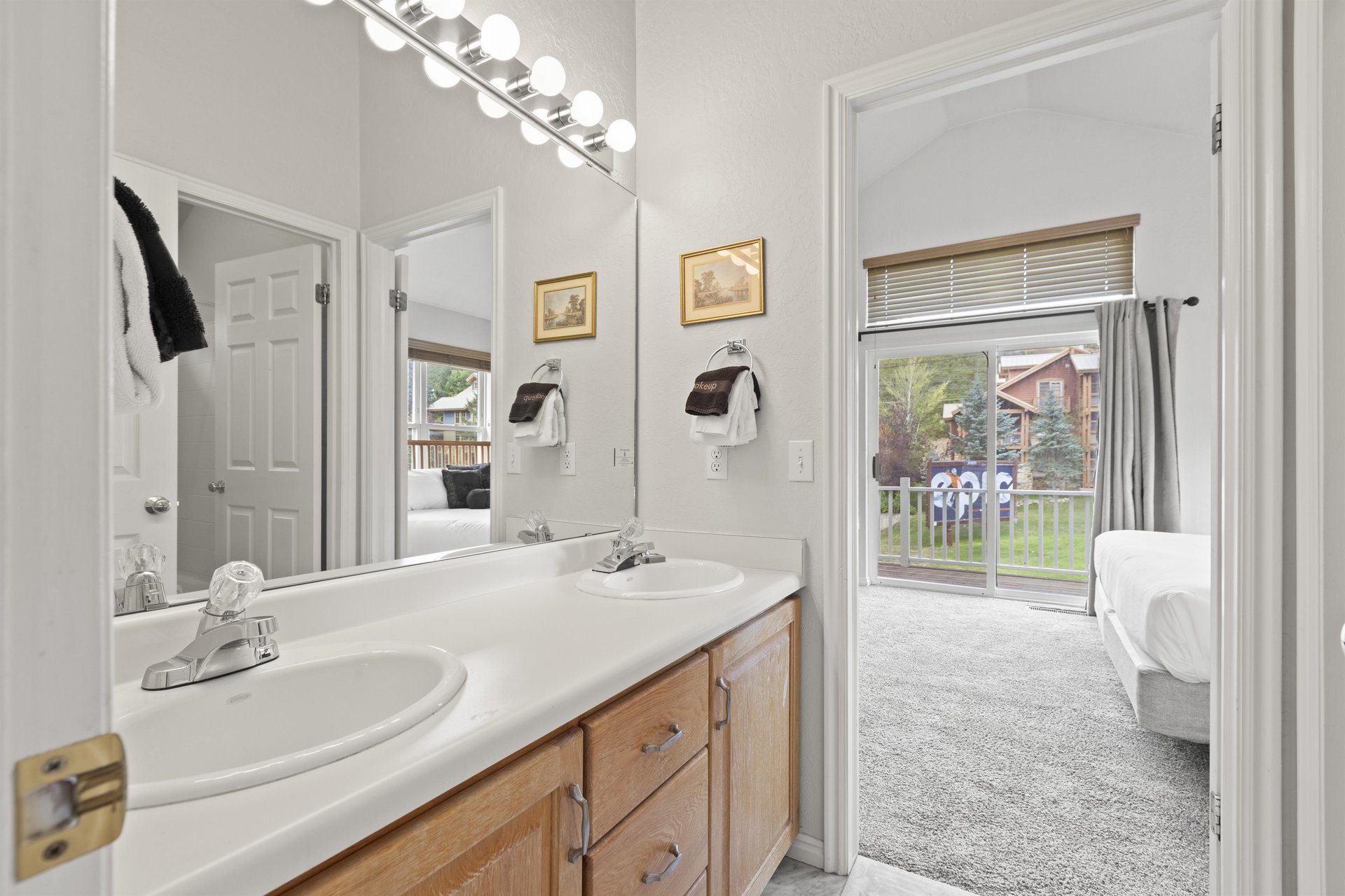 The en suite bathroom has a double sink vanity.