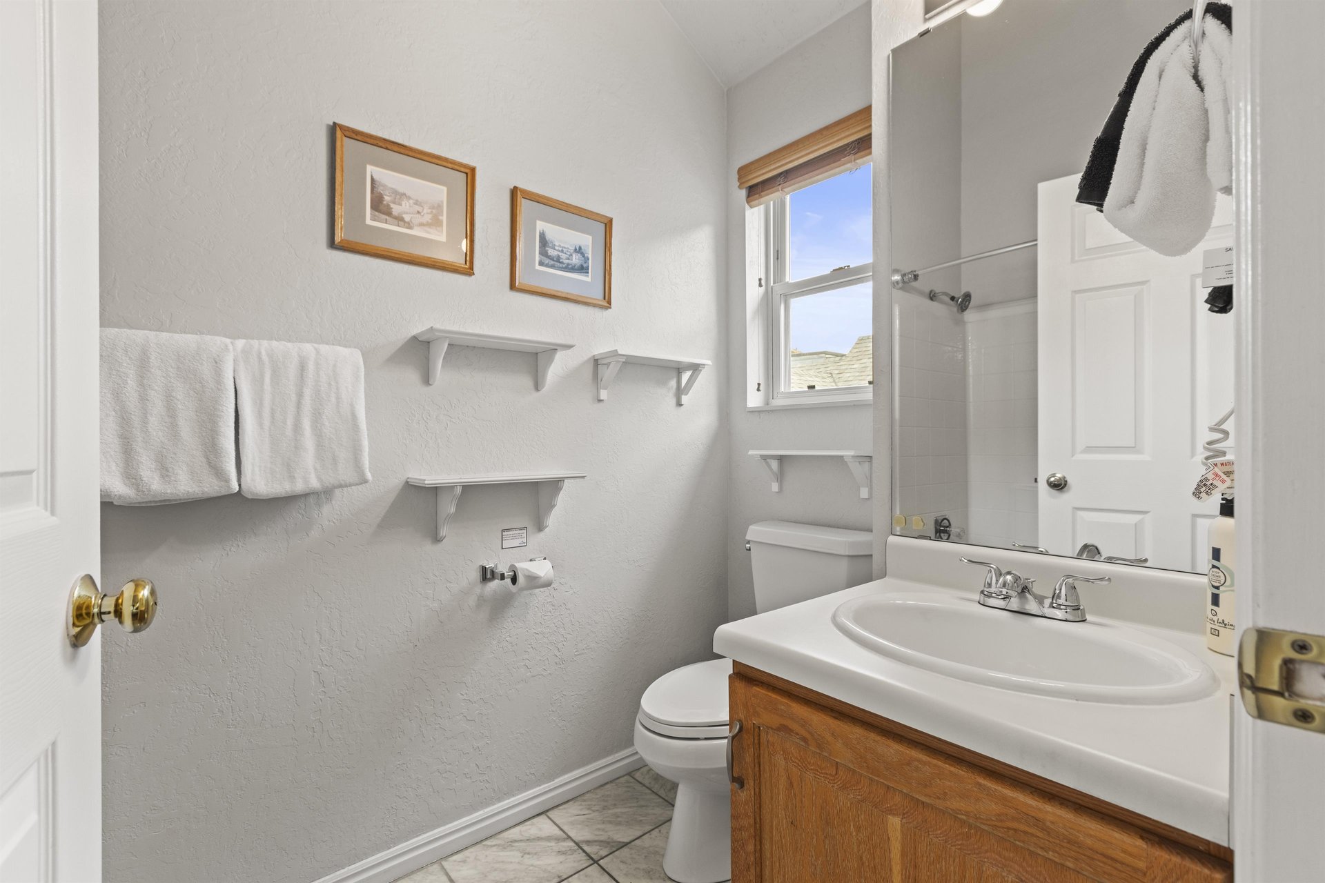 The bathroom with a single sink vanity.