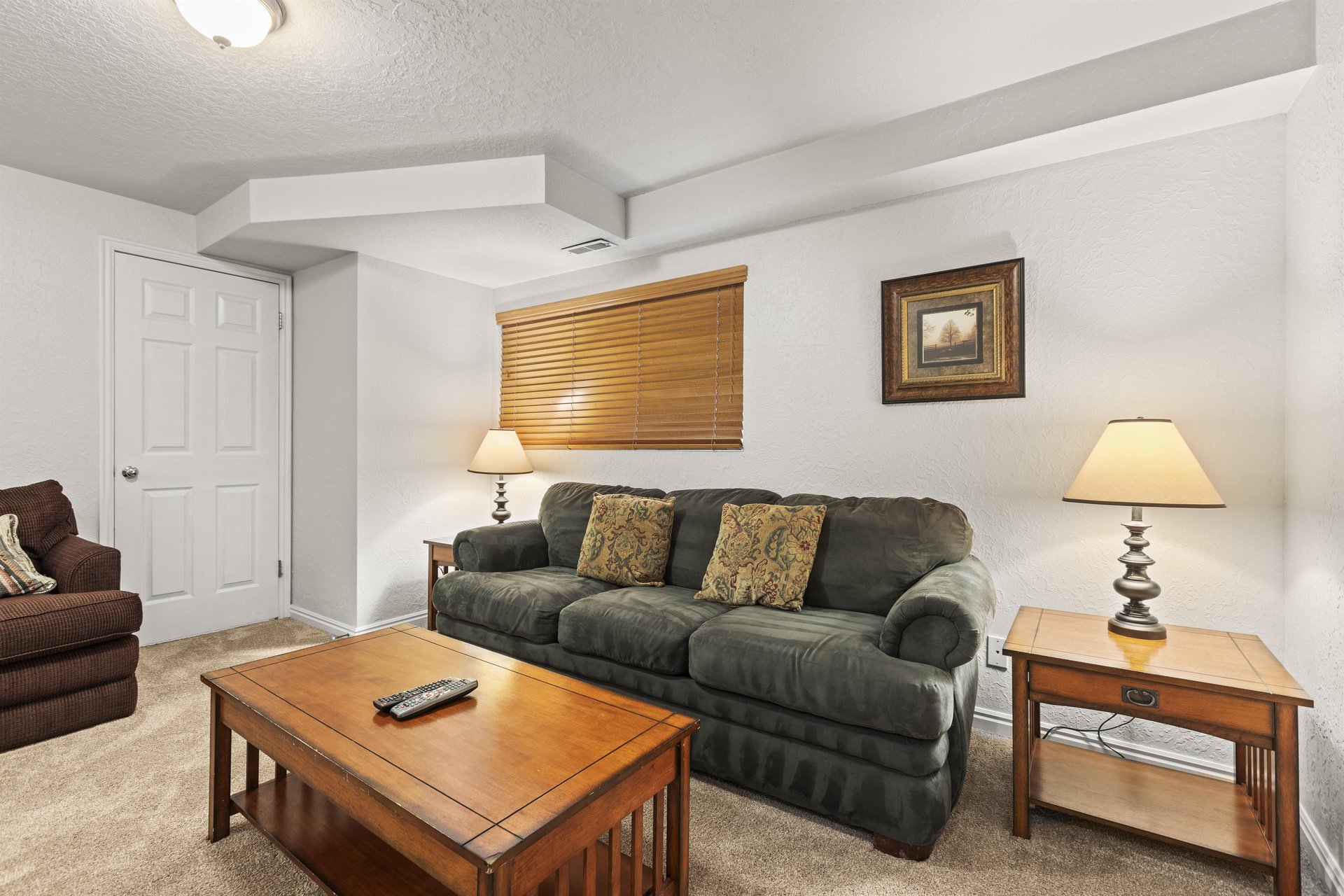 The third living area with comfortable seating and wood furniture.