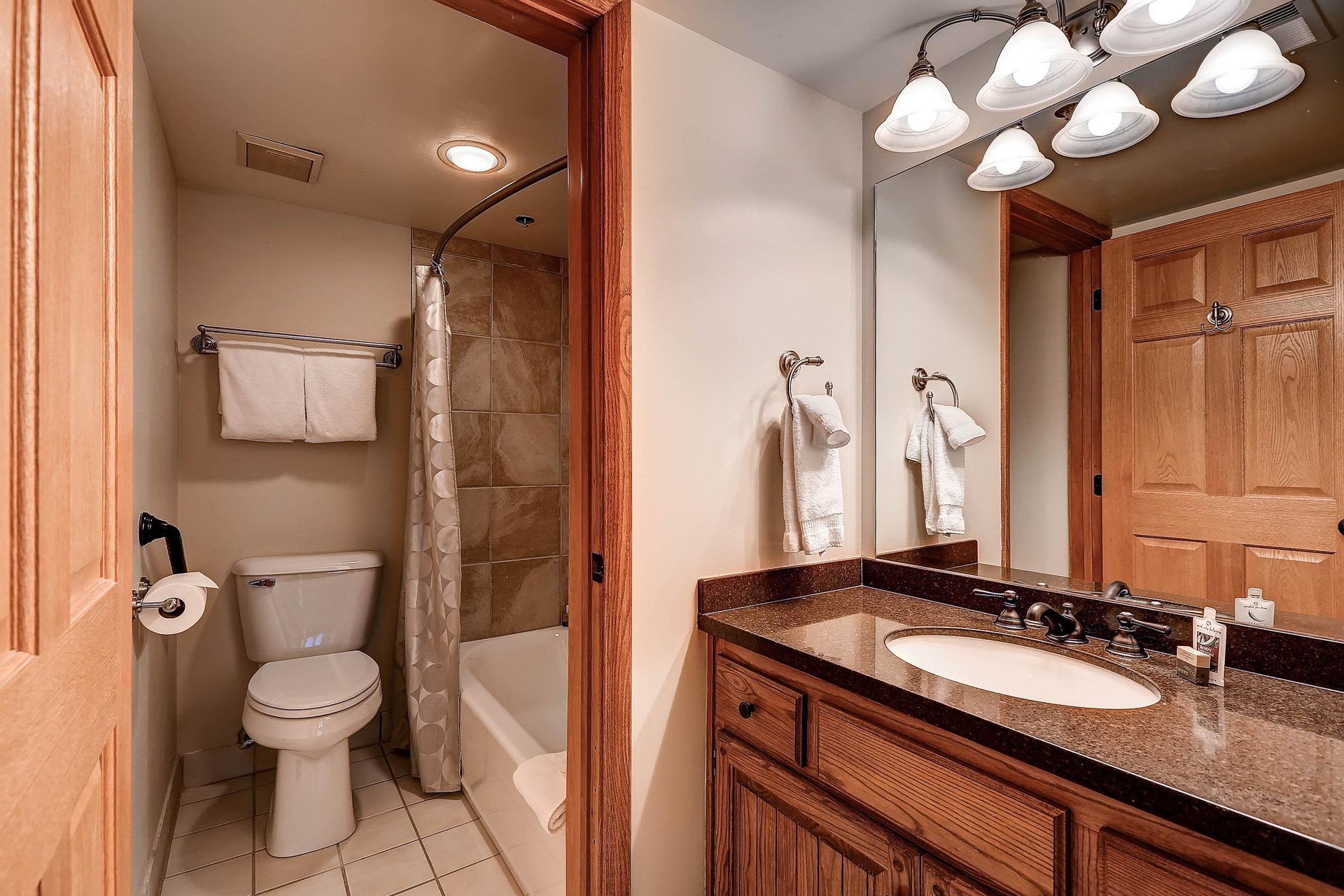 The en suite bathroom has a single sink vanity and separate water closet.