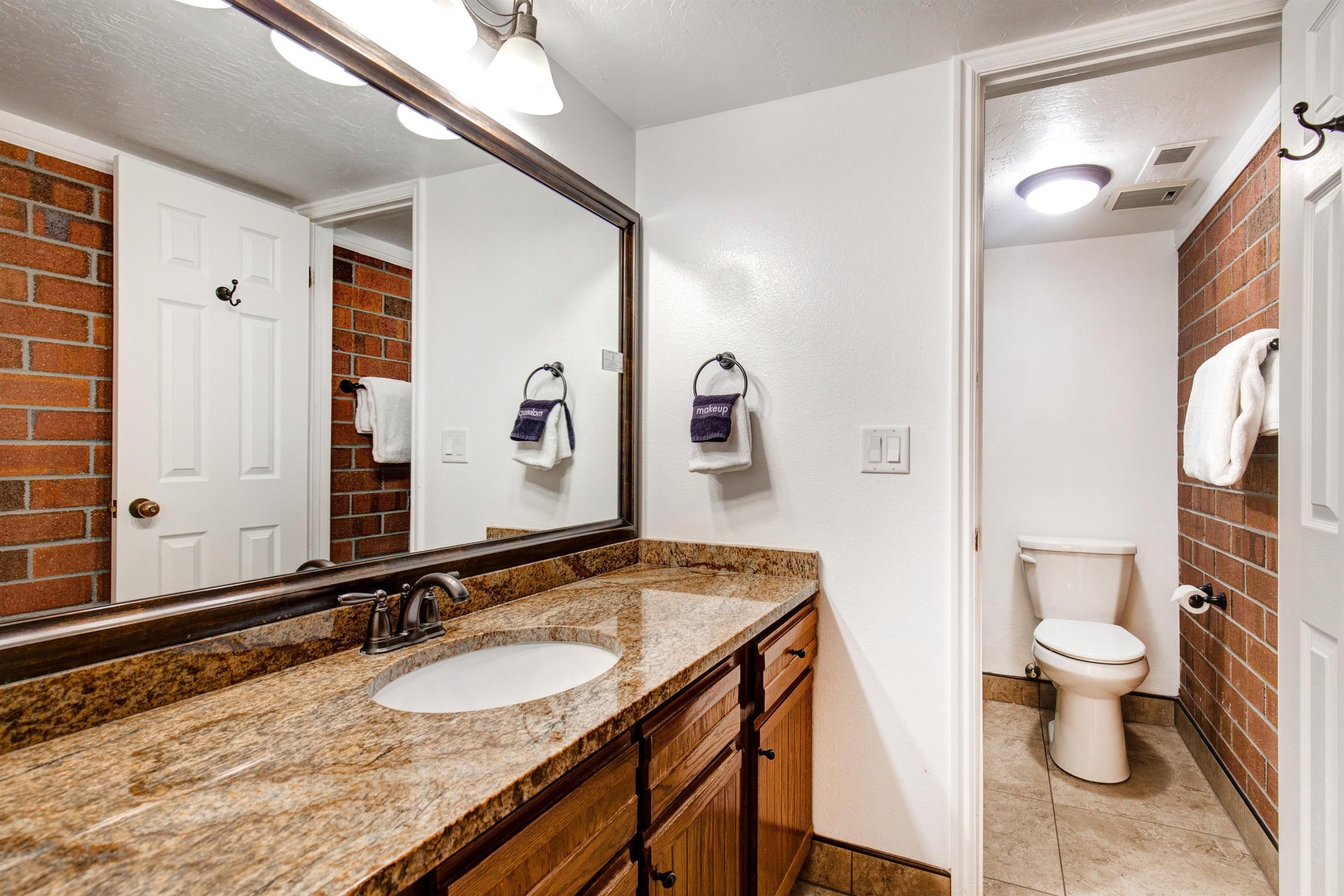The shared bathroom has a single sink vanity and separate water closet.