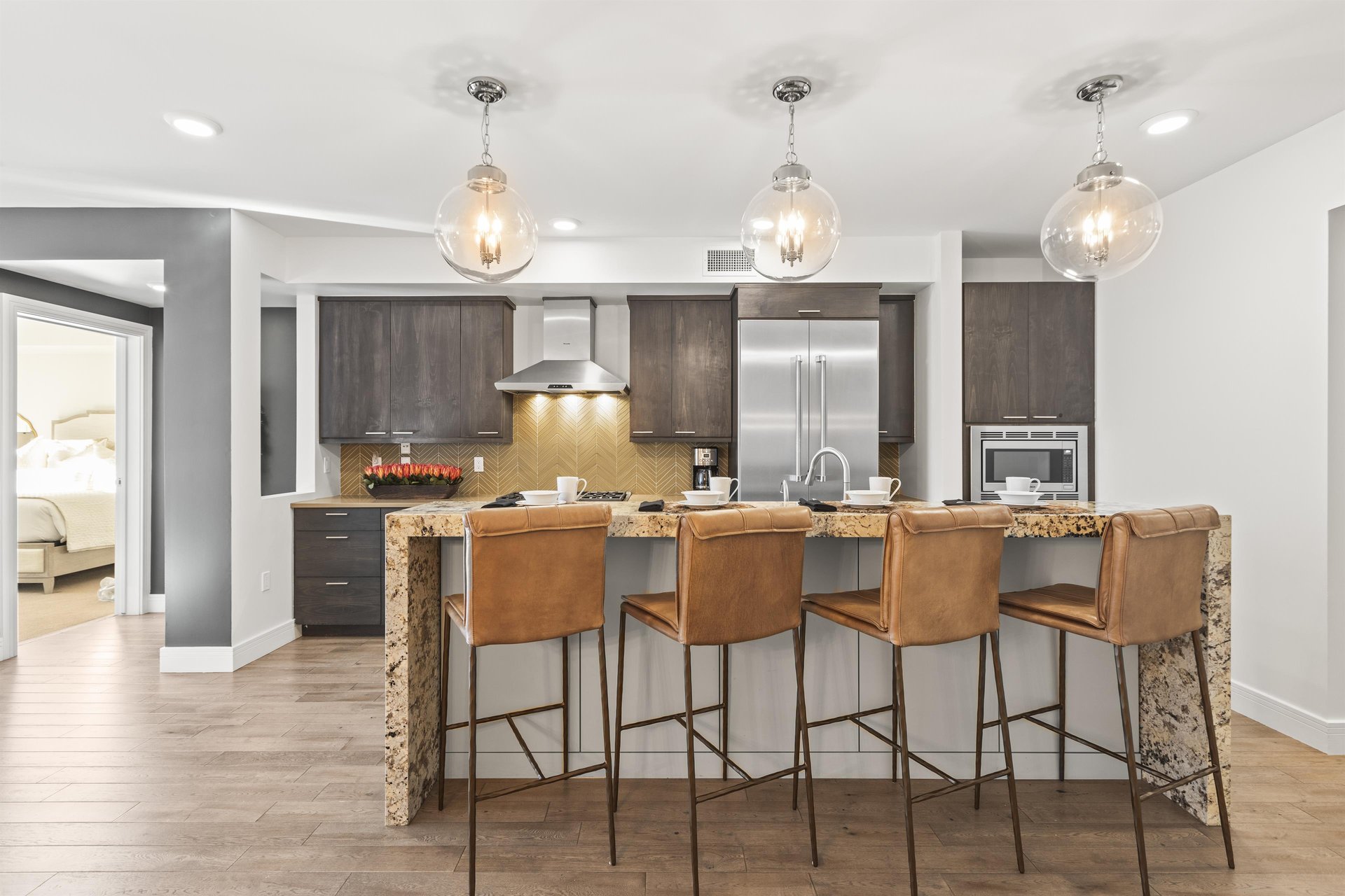 The island has seating for 4 on metal and leather stools.
