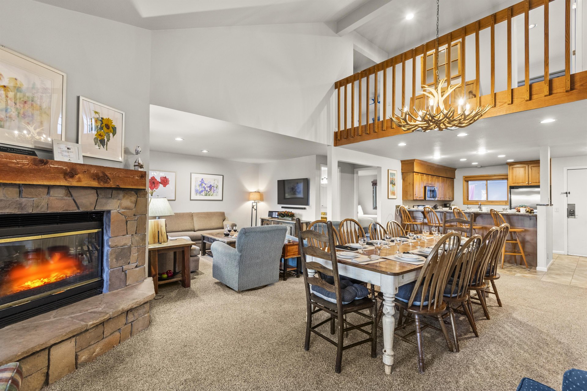 The open concept living, dining, and kitchen area with a gas burning fireplace.