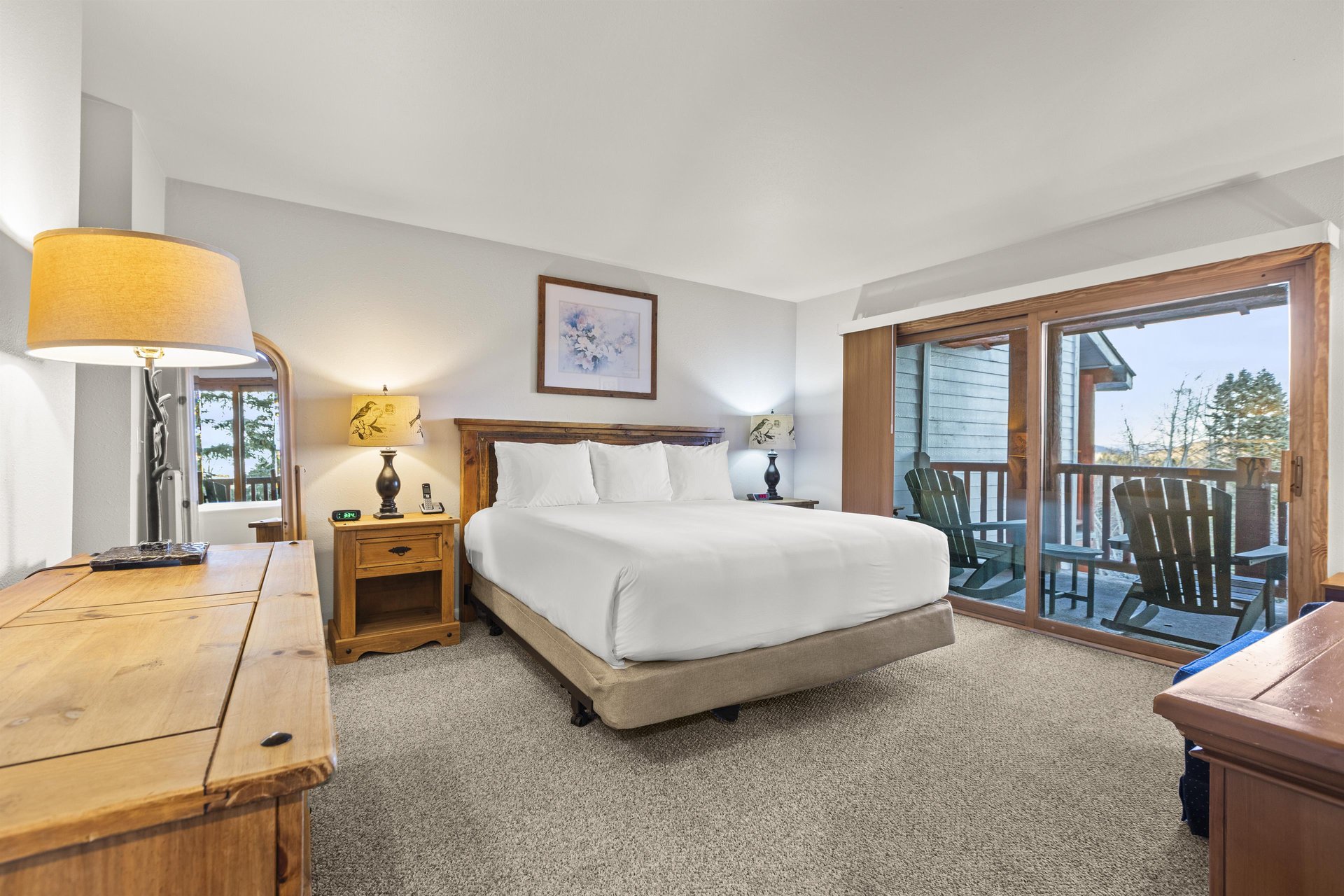 The main suite with a kingsize bed and wood headboard.