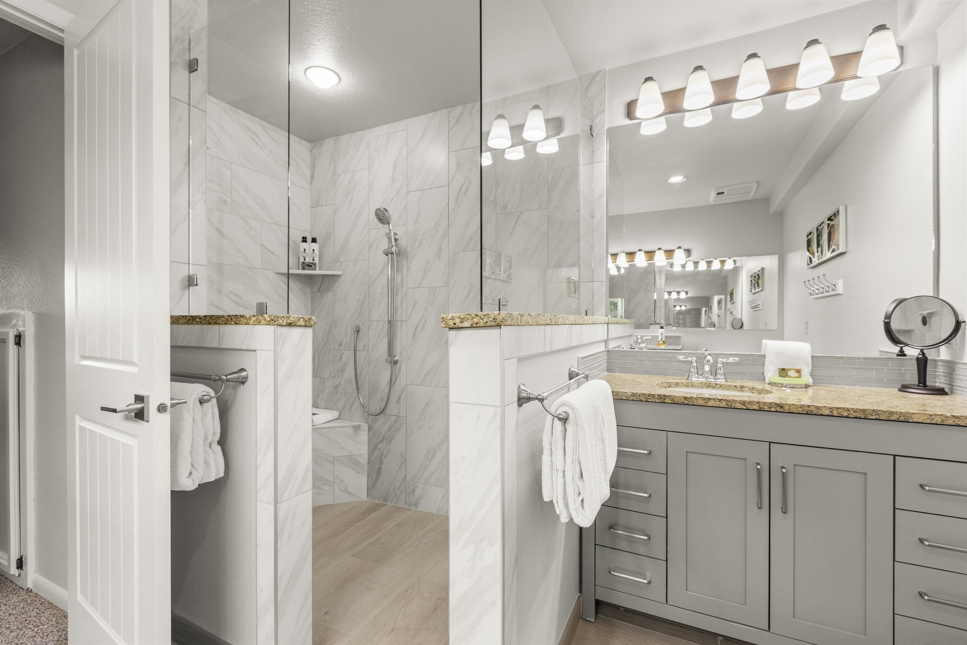 The en suite bathroom has a walkin shower and glass door.