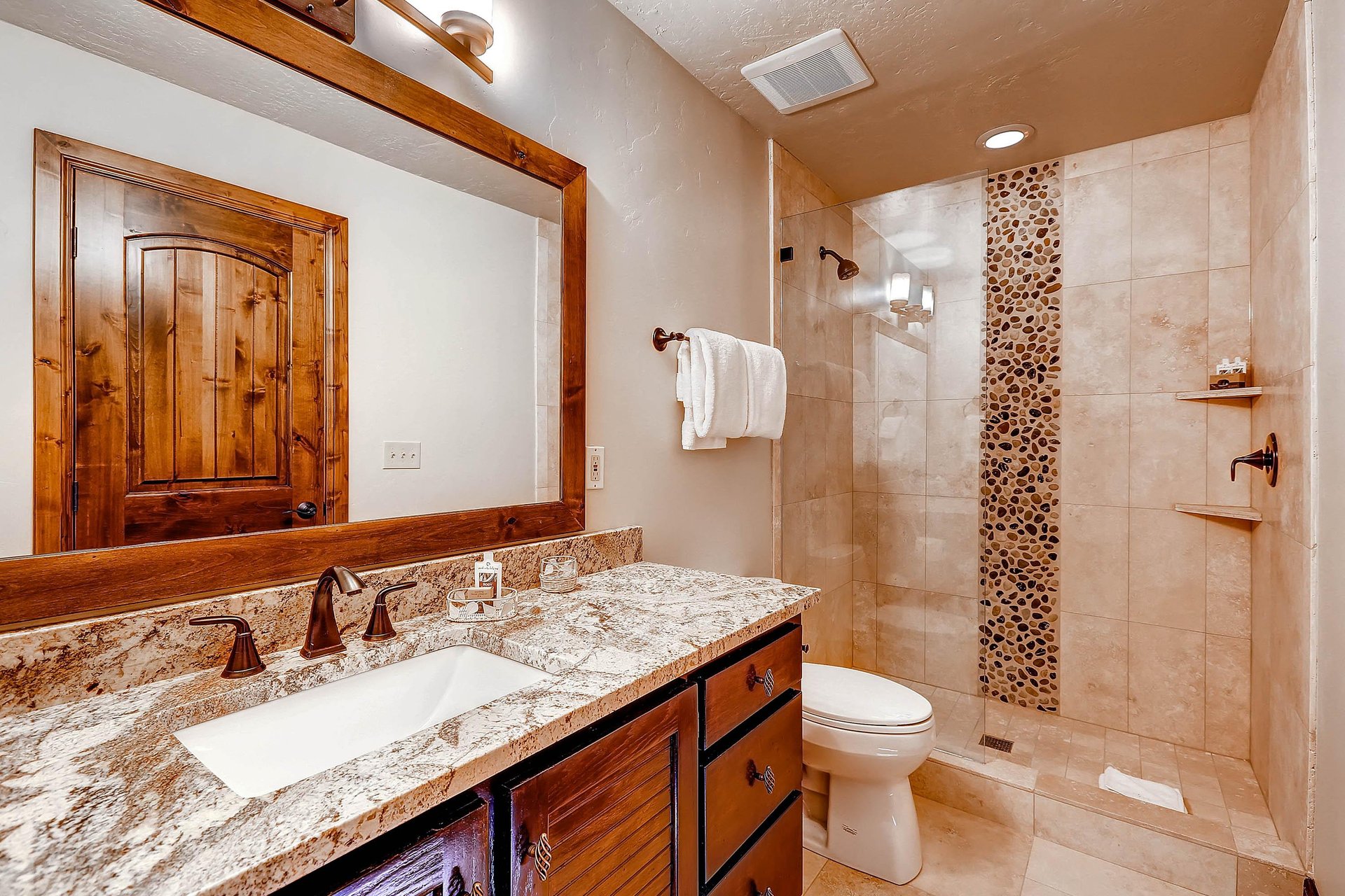 The main suite has an en suite bathroom with one sink vanity and walkin shower.