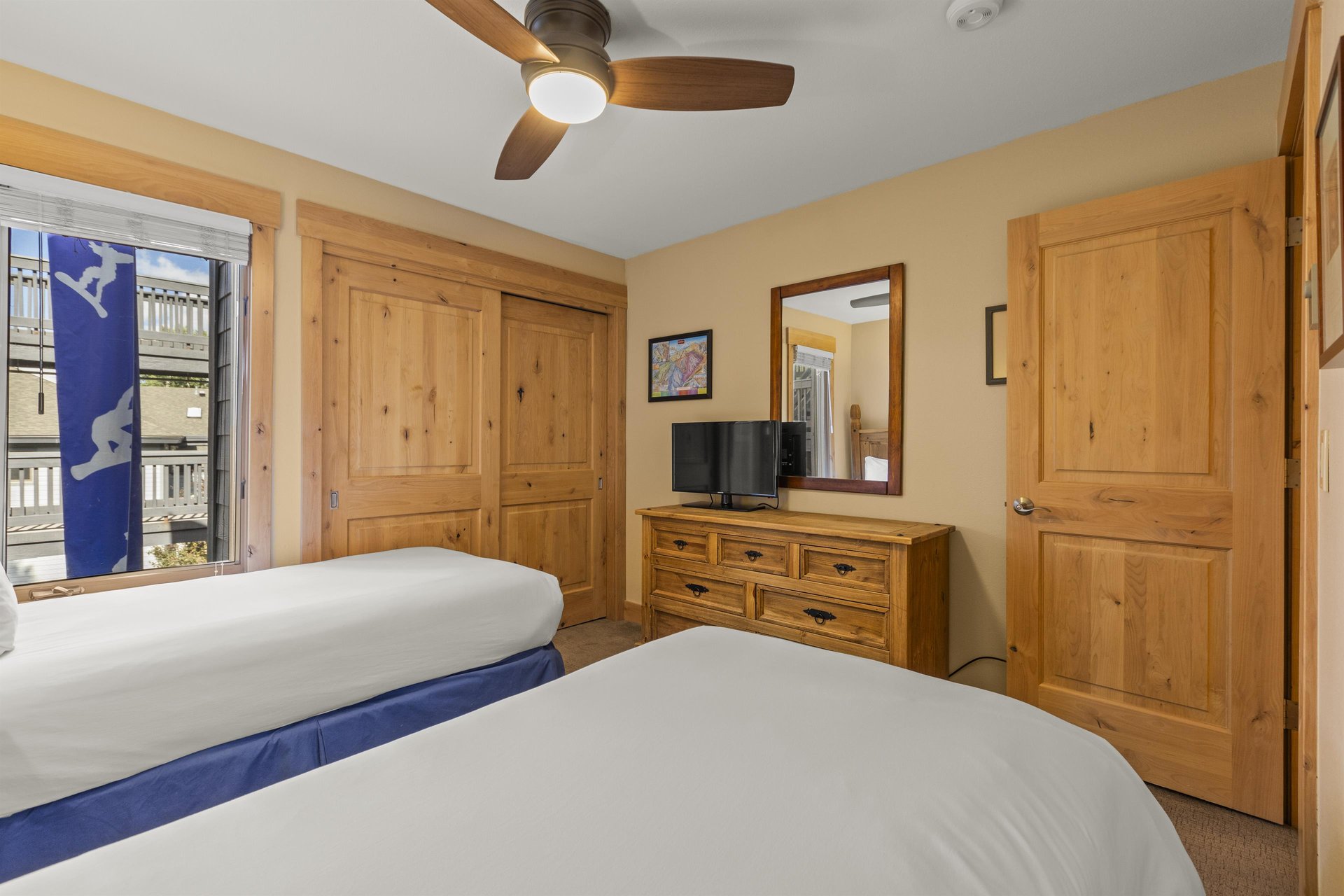 The second bedroom has two twin beds and flat screen TV.