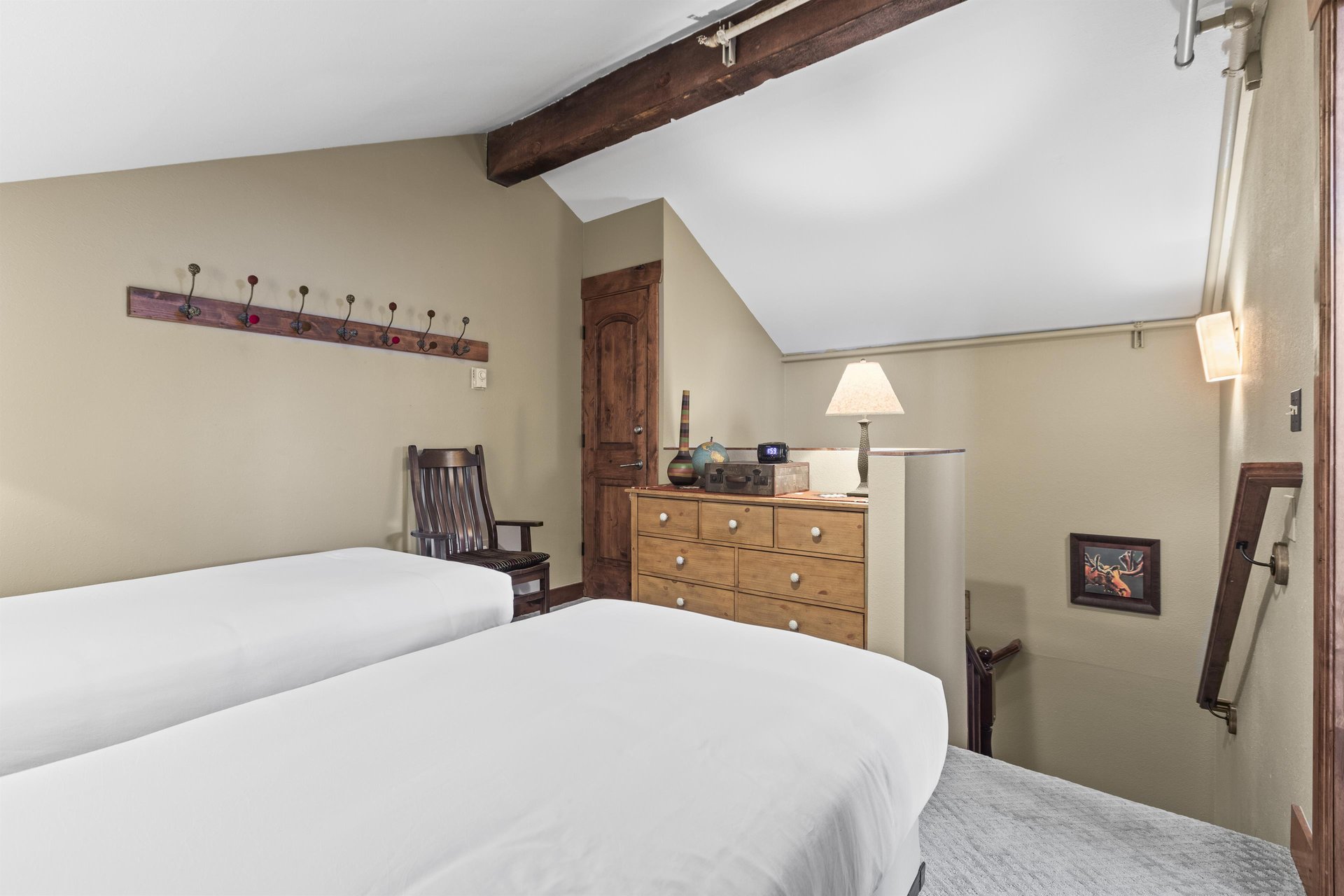 The loft offers two twin beds and wooden dresser.