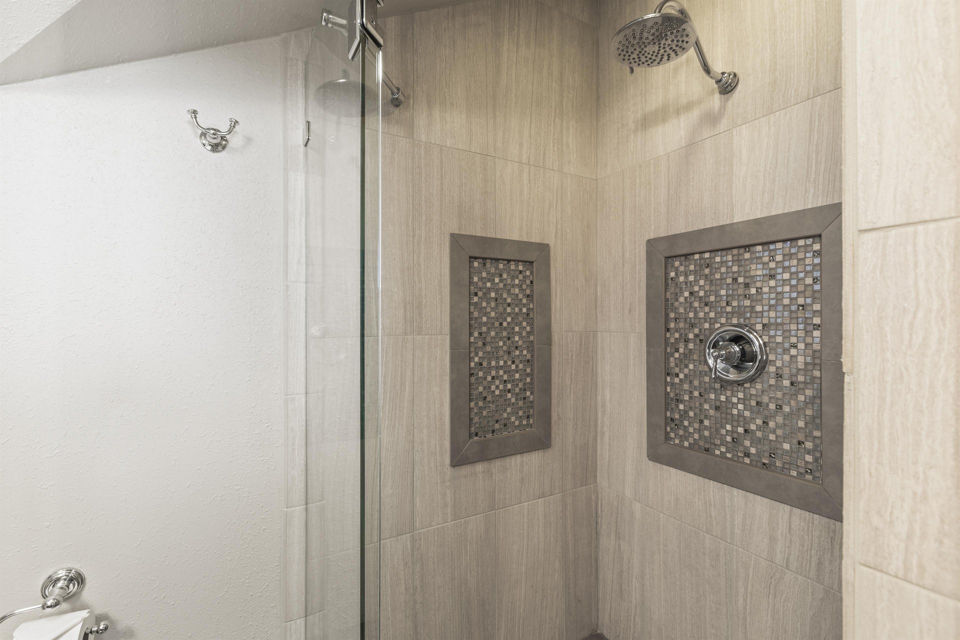 The en suite bathroom offers a walkin shower with beautiful tile.