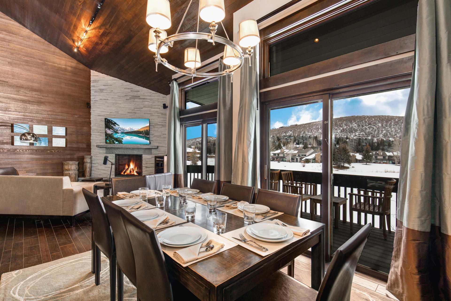 The dining room with large sliding glass windows with lake and mountain views.