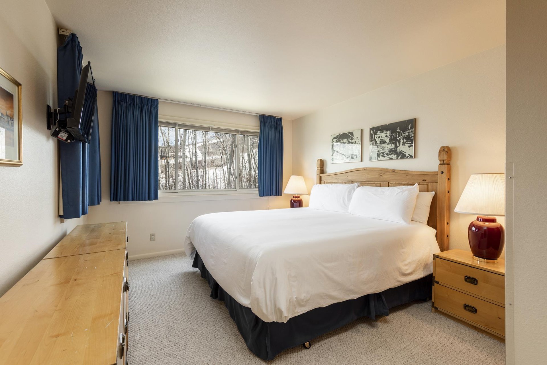 The main bedroom with a king size bed overlooking aspen groves