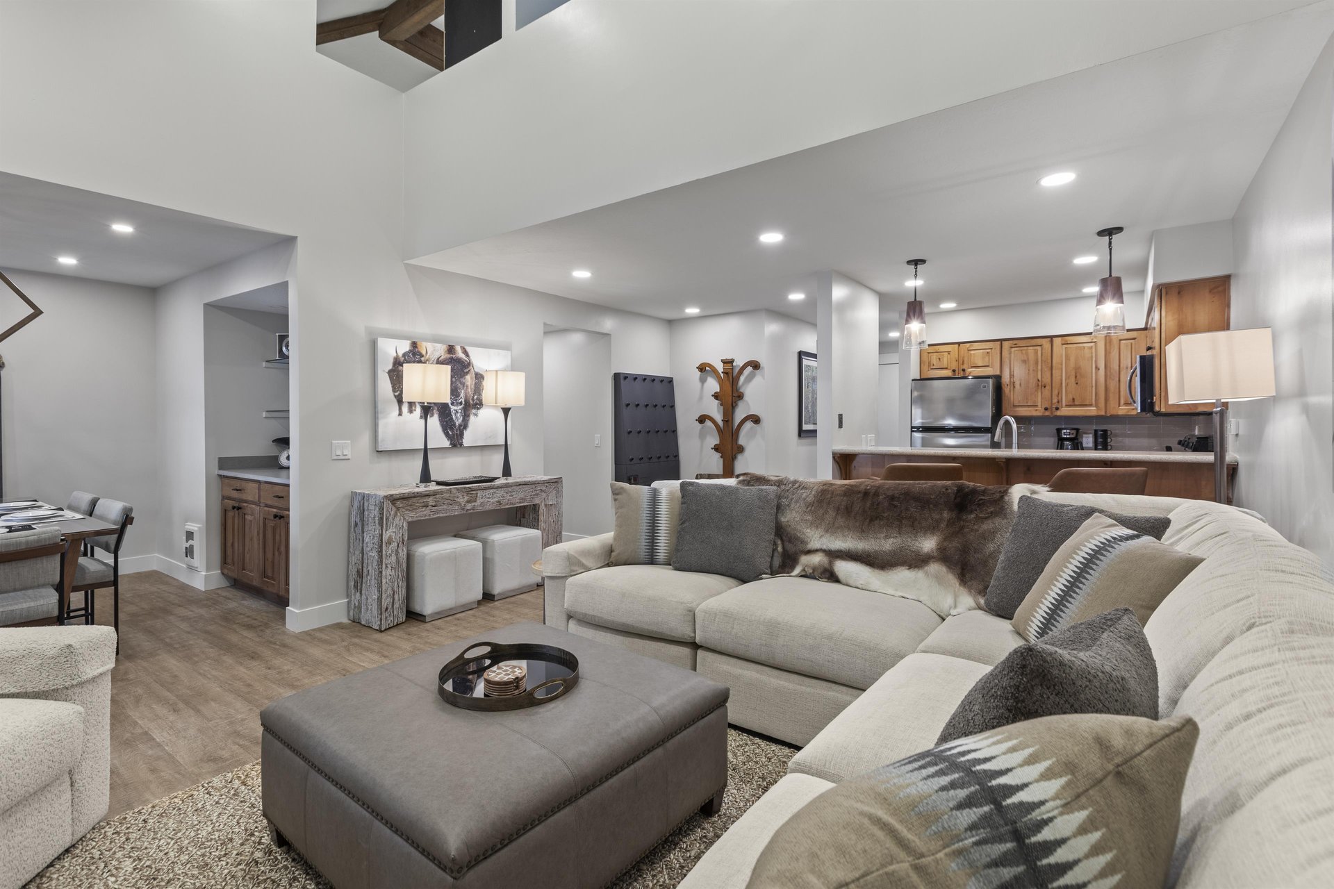 The open concept living room and kitchen area with stylish decor.