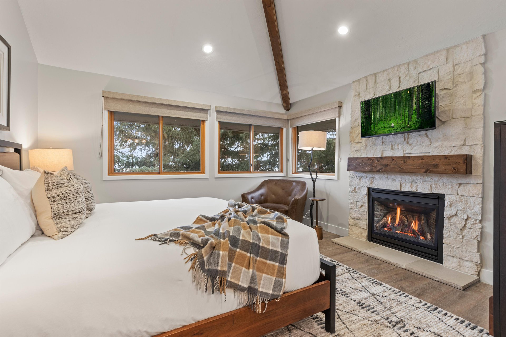 The main suite offers a kingsize bed, wood burning fireplace, and flat screen TV.