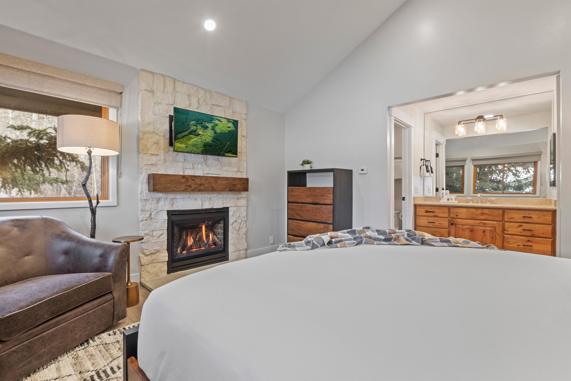 The main suite offers a kingsize bed, wood burning fireplace, and flat screen TV.
